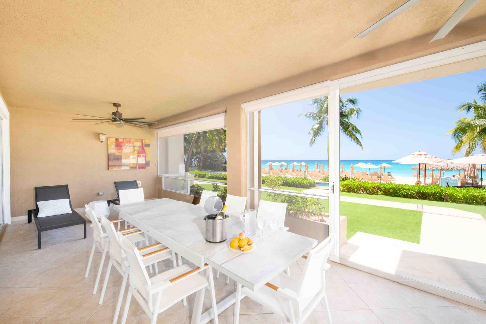 Furnished screened patio with easy walkout access to the pool deck and beach.