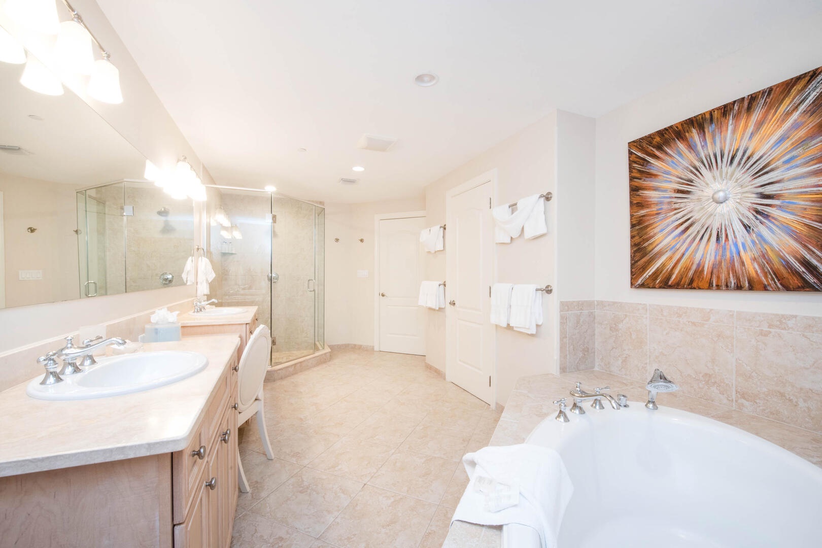 Primary ensuite with dual vanity and beauty counter, plus a soaking bathtub and separate shower.