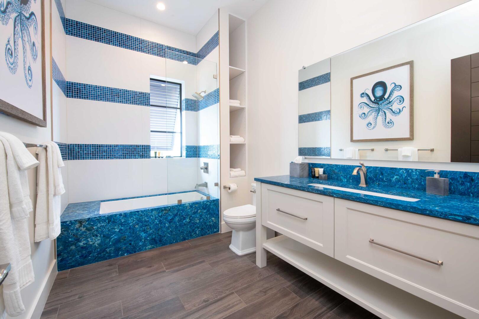 Bunk Suite ensuite bath with double vanity, and tiled tub/shower.