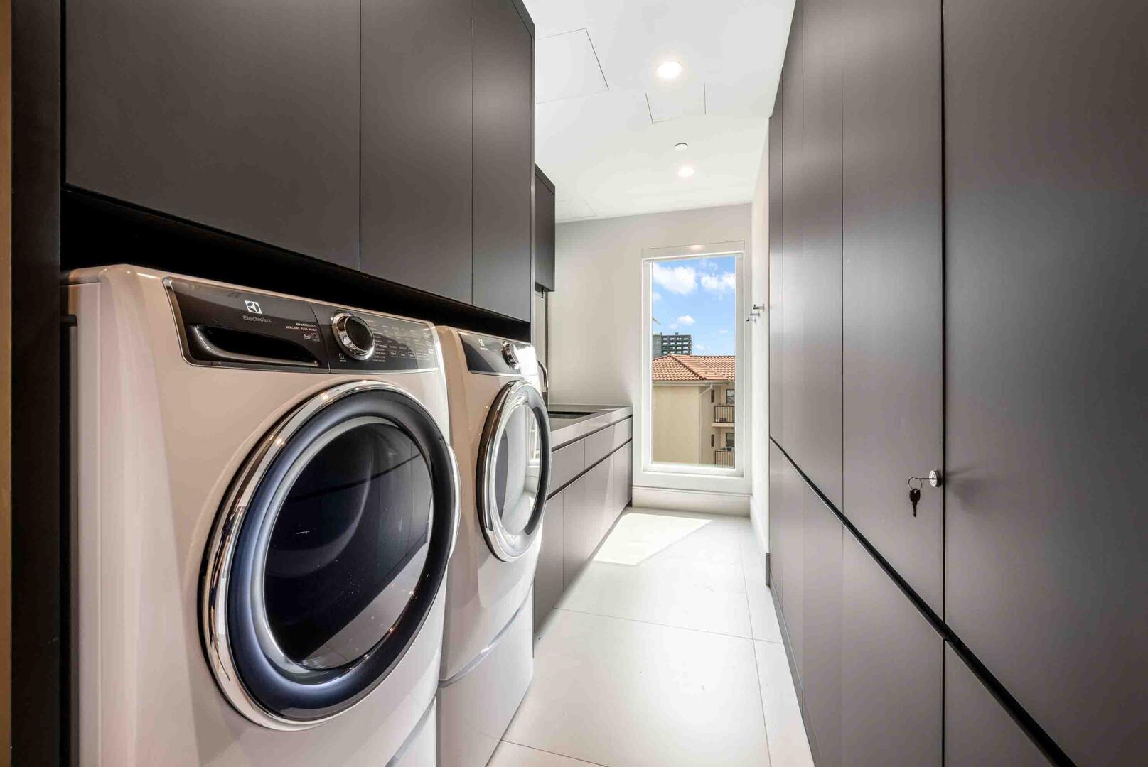 In-unit laundry room with washer and dryer.