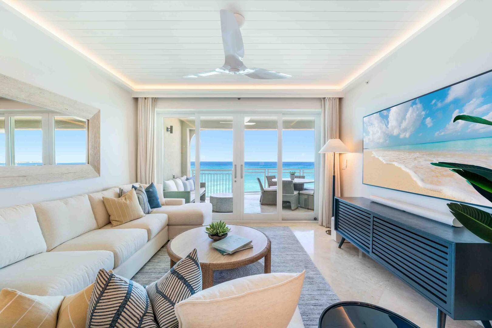 Living area with sectional sofa, HD television with soundbar, and stellar views.