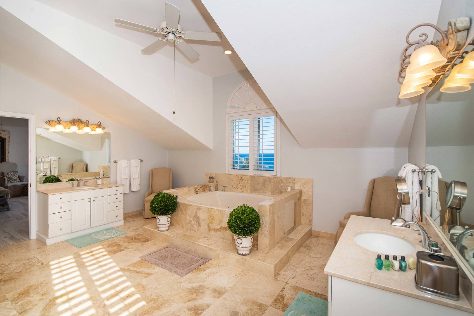 Primary ensuite with dual vanity and soaking tub.
