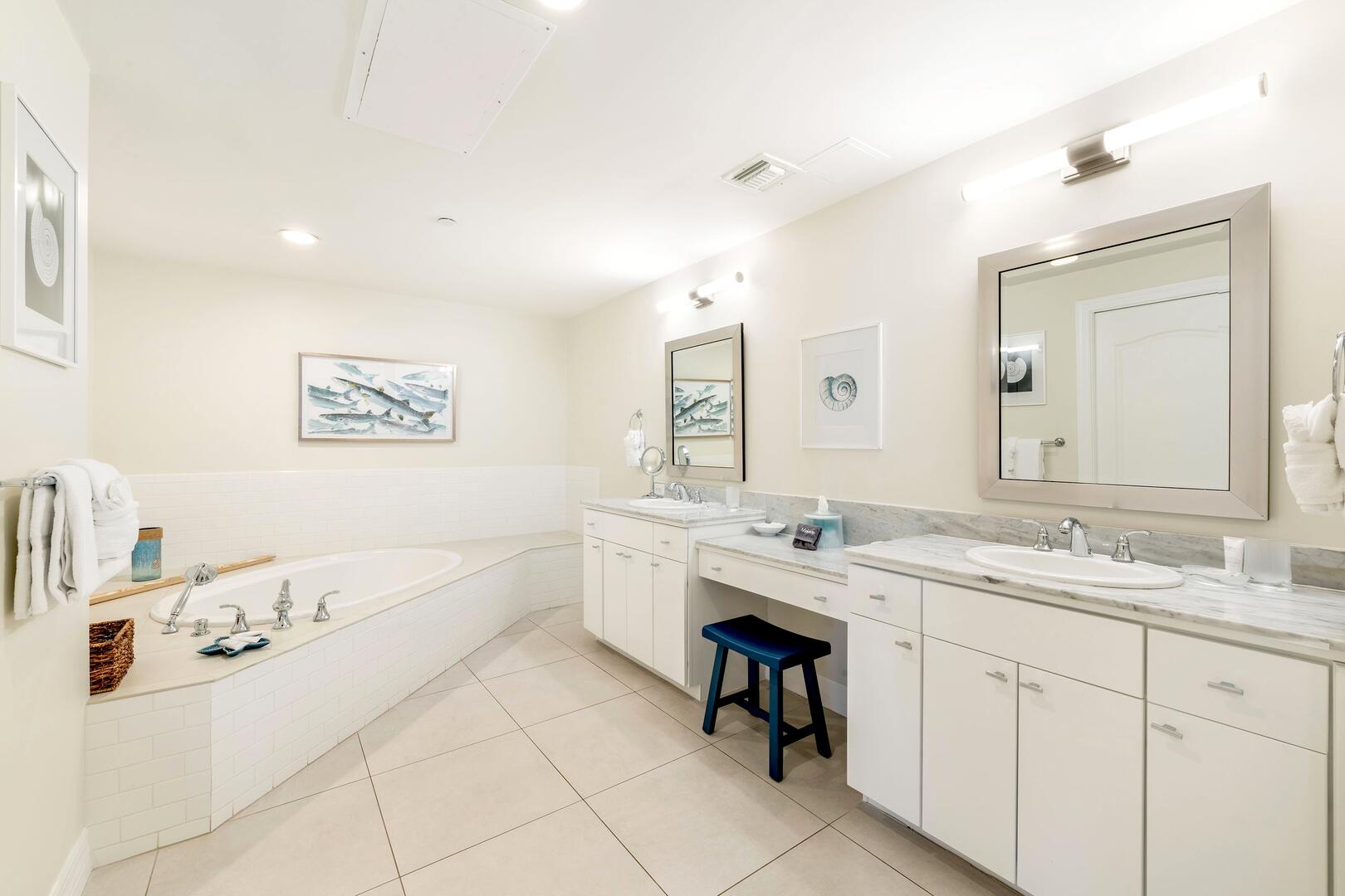 Primary ensuite with dual vanity, beauty counter, and soaking bathtub. All bath and beach towels are provided during your stay.