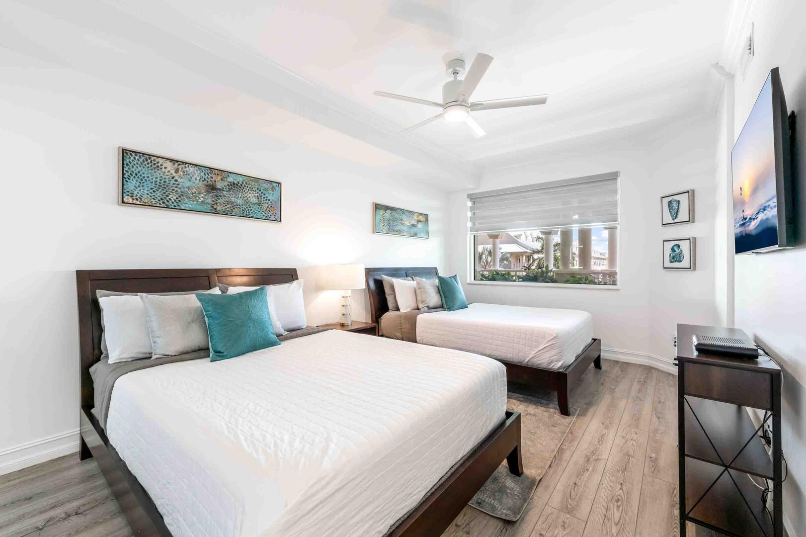 Guest Suite #2 with two queen beds and an HD cable television.