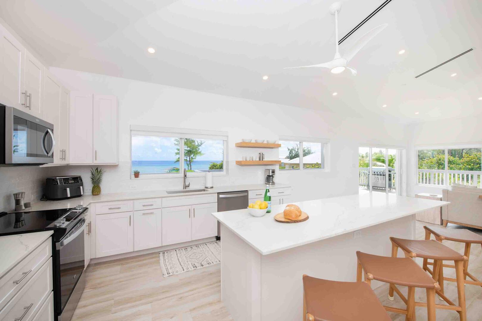 Spacious full kitchen with modern appliances and island seating.