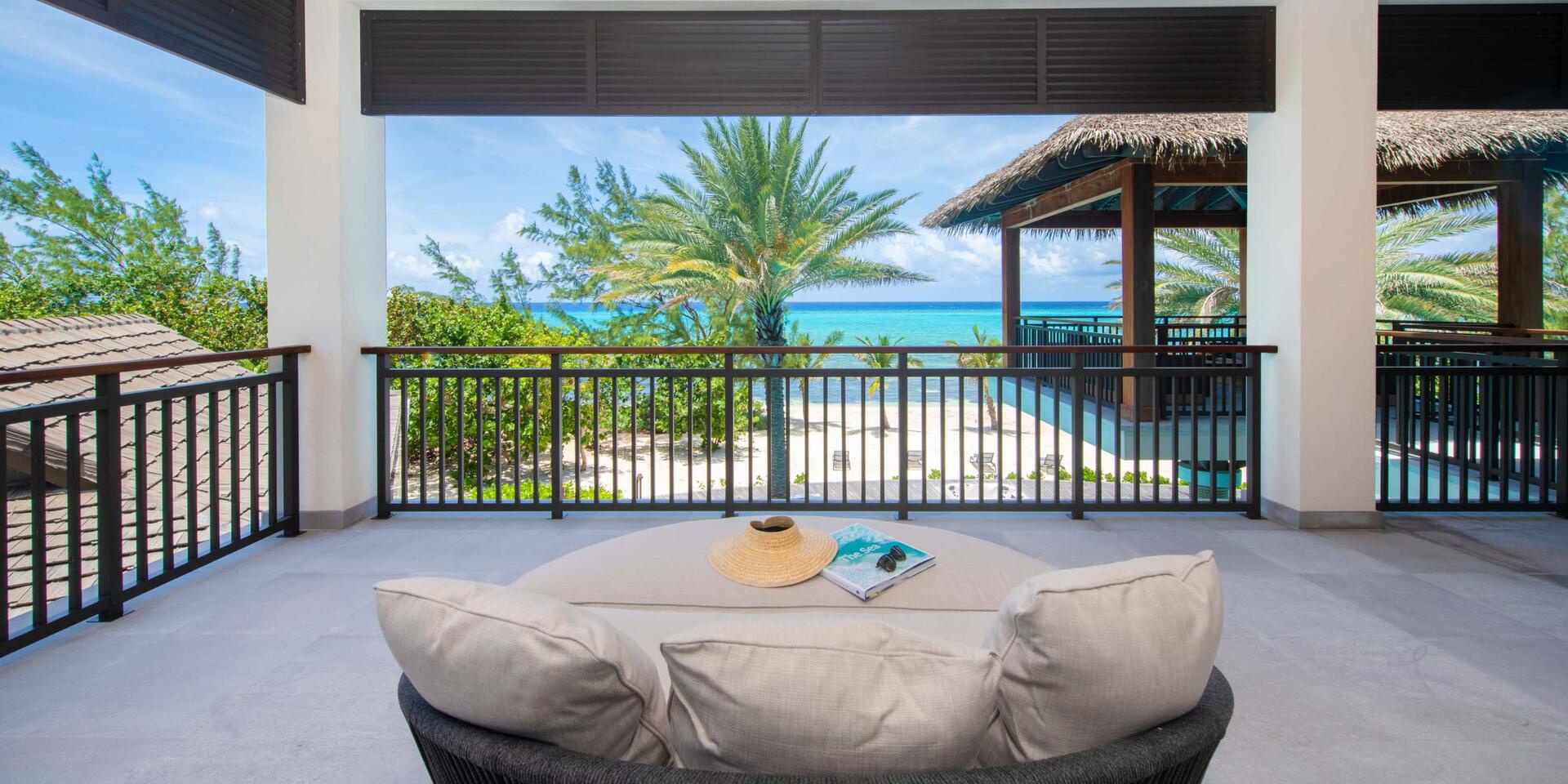 Comfy daybed on the veranda balcony for afternoon siestas by the sea.