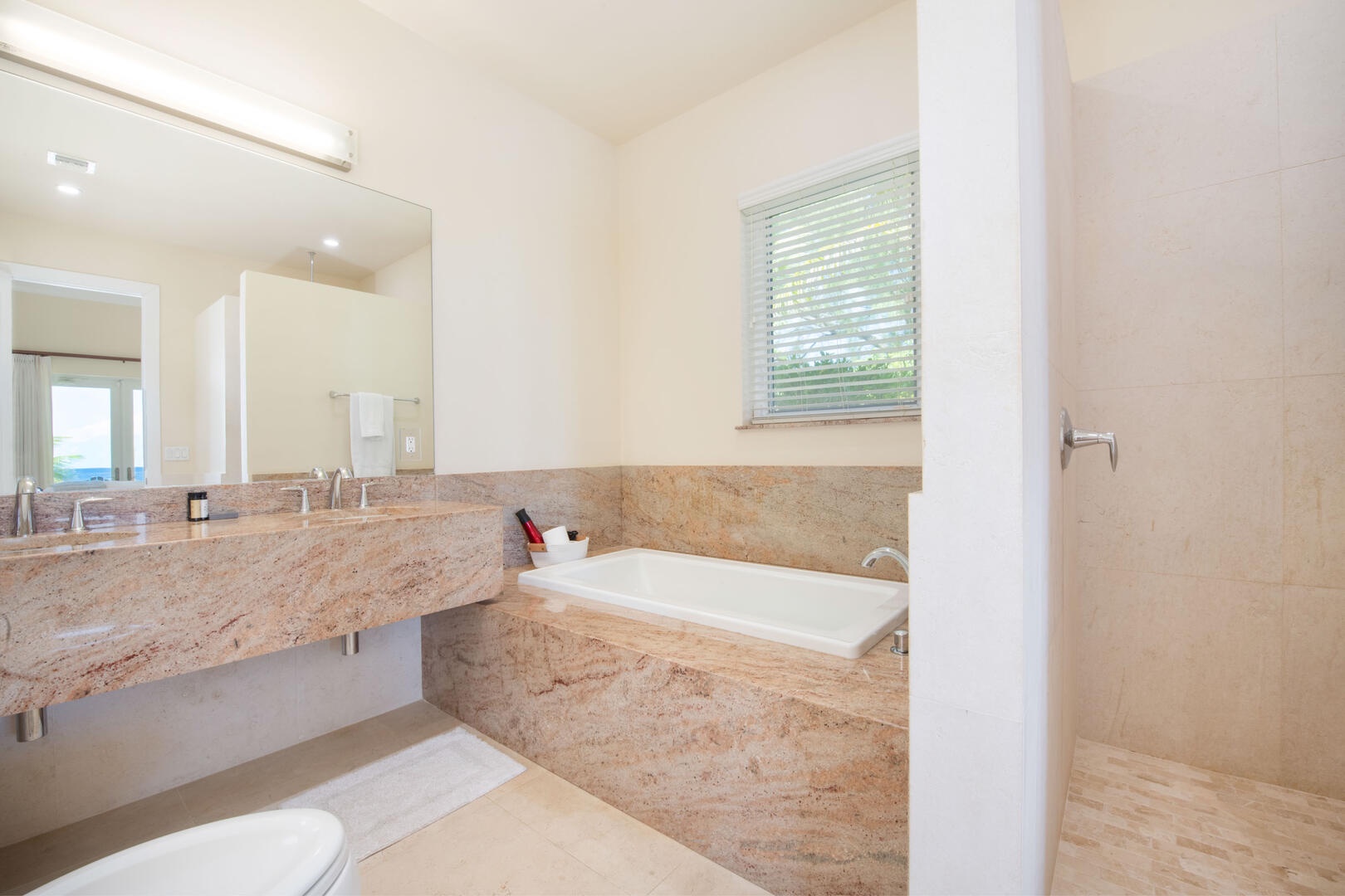 Guest Ensuite #1 with dual vanity, soaking tub, and separate shower.