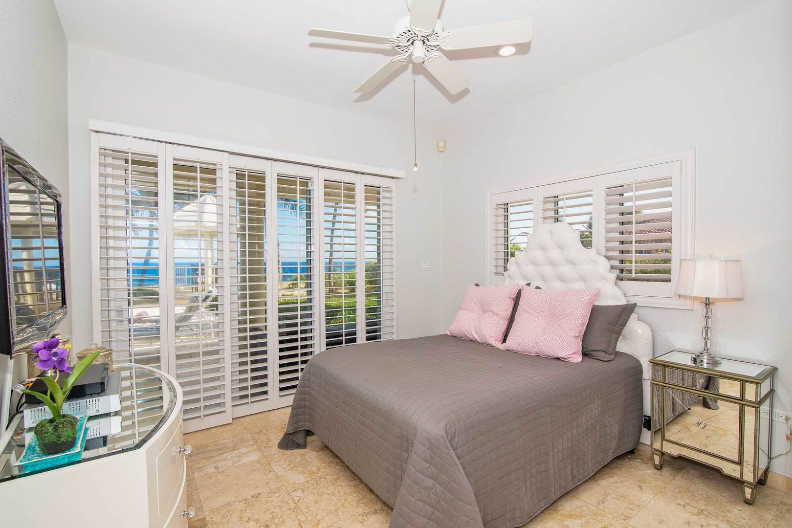 Bedroom #5 on the lower level with walk-out access to the veranda and pool deck.