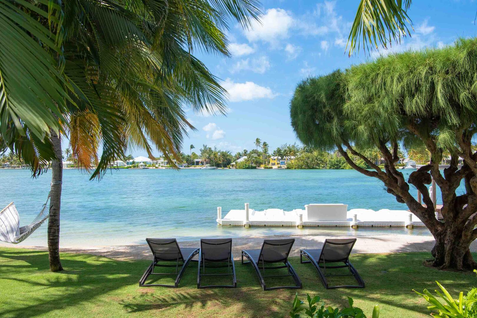 Beachfront with sun loungers in the shade.
