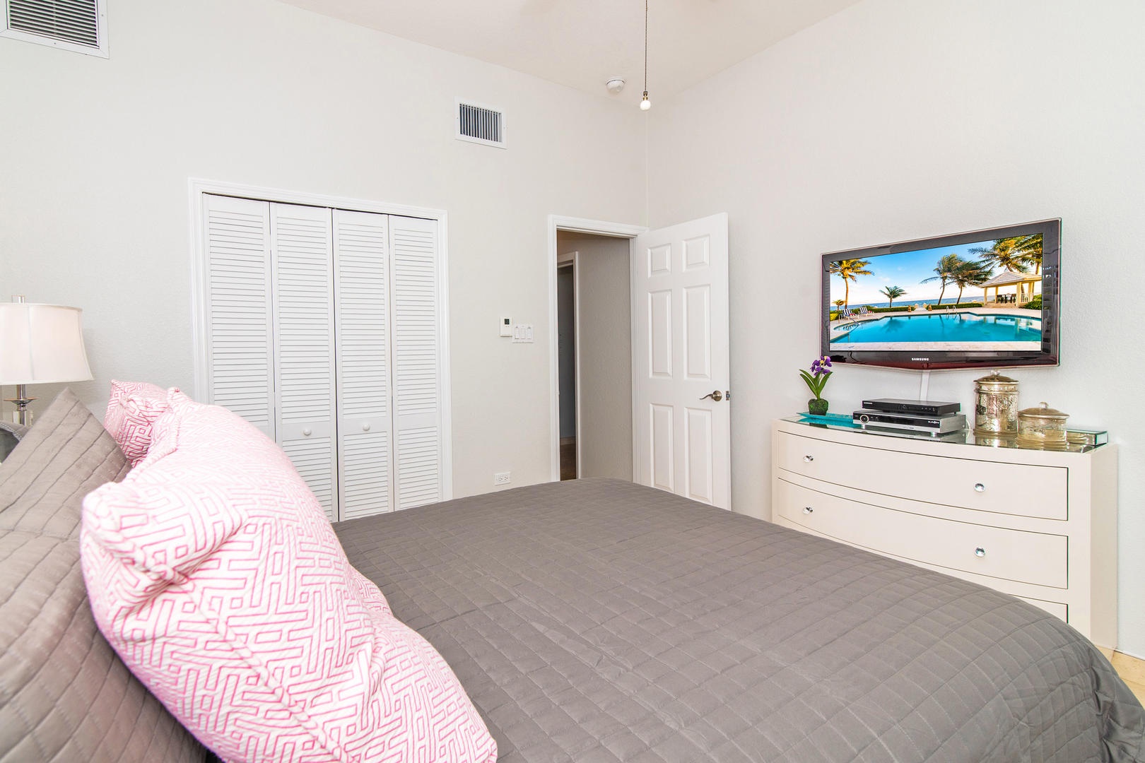 Bedroom #5 furnished with queen bed and television.