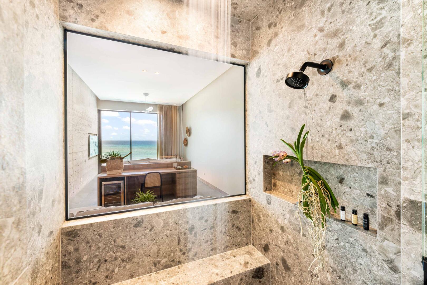 Suite 1 ensuite bathroom with double vanity, multiple mirrors, lighted make-up station, walk-in oceanview shower