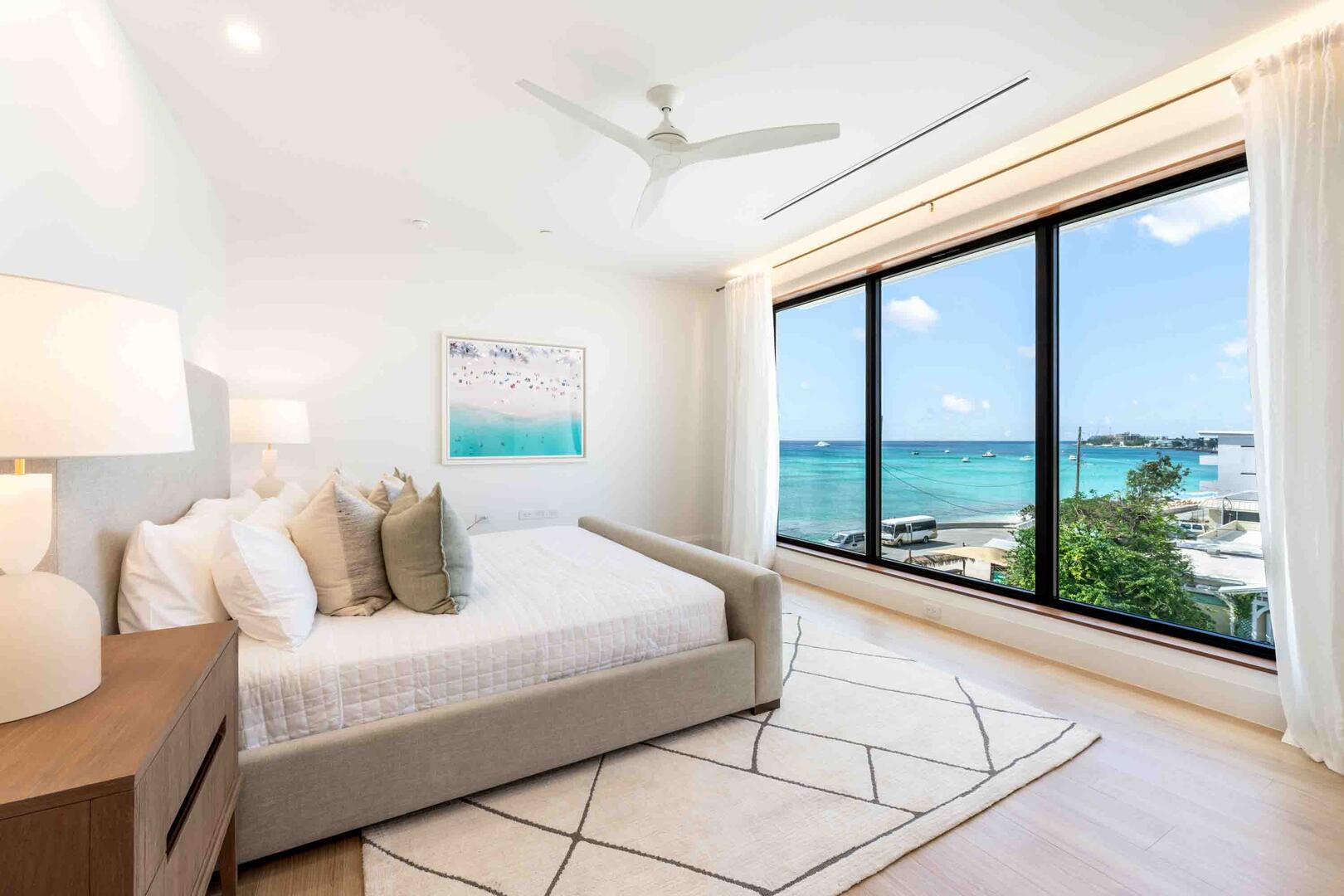 Bedroom 1 with a king bed, television, and ocean views. All linens and bedding are provided during your stay.