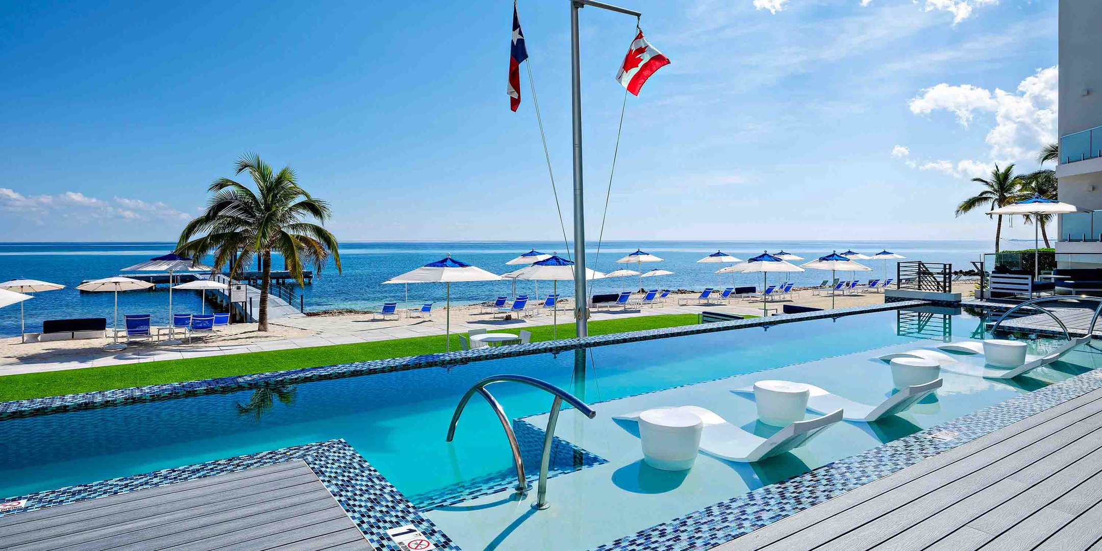 Resort pool with ledge loungers and oceanfront views. The pool is heated in winter months.