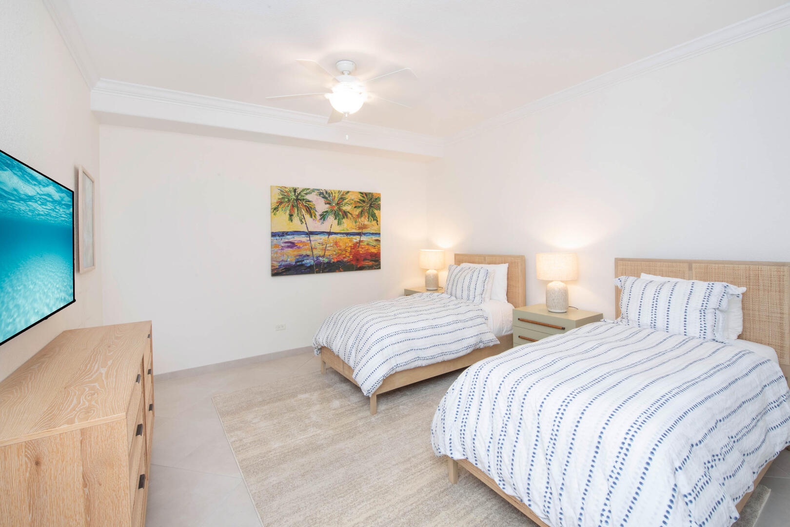 Bedroom 2 furnished with two twin beds and cable HD TV.