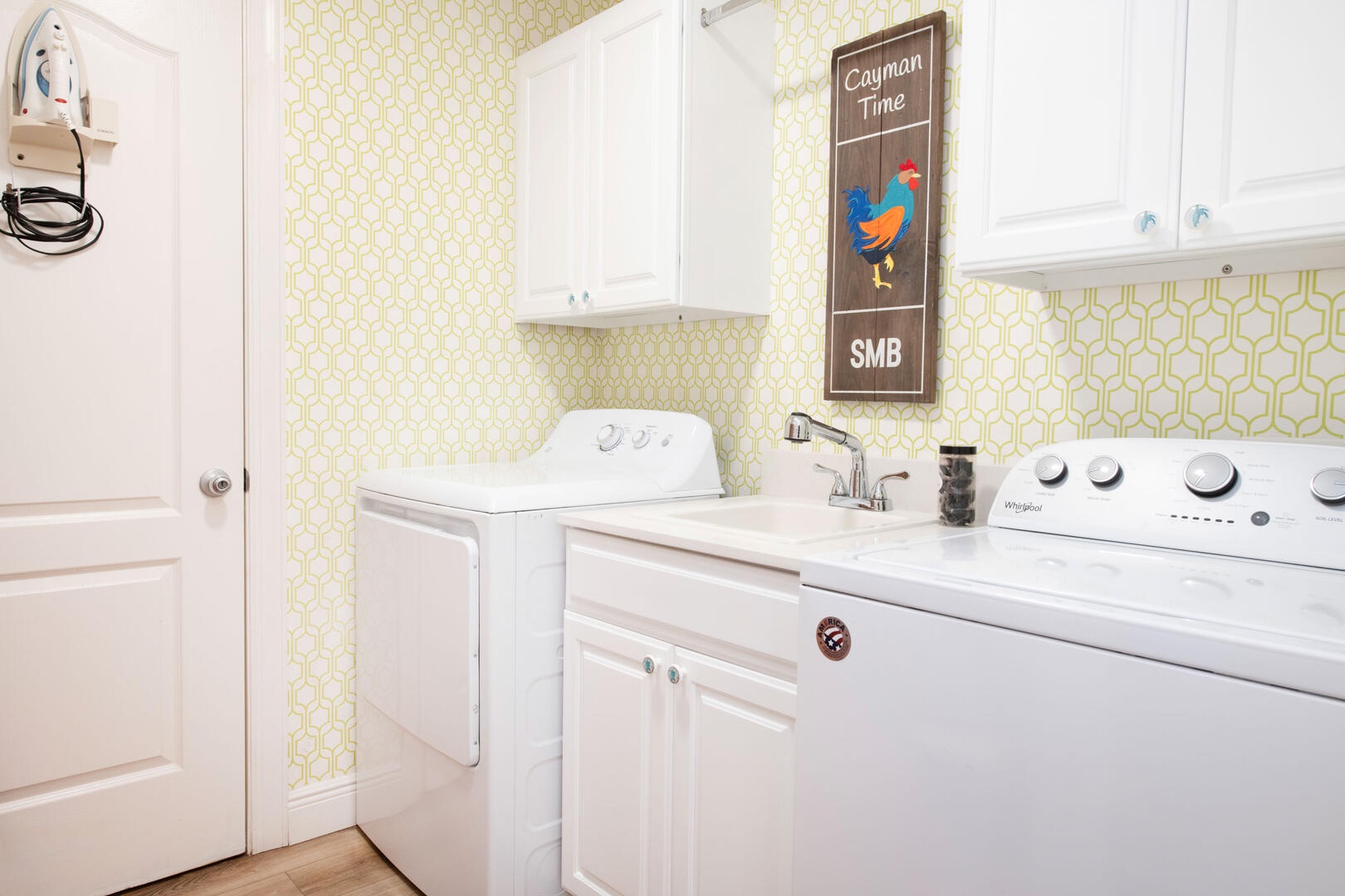 In-unit laundry room with washer and dryer plus utility sink.