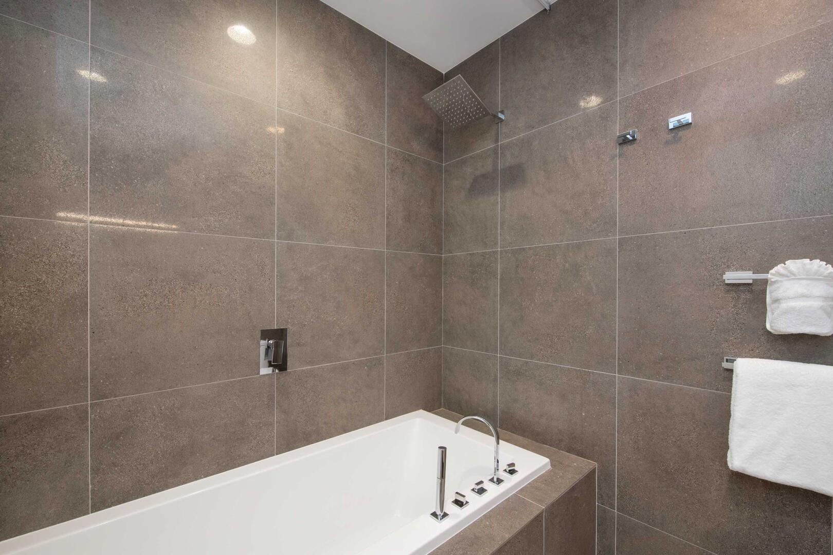 Ensuite bathroom with tub and shower.