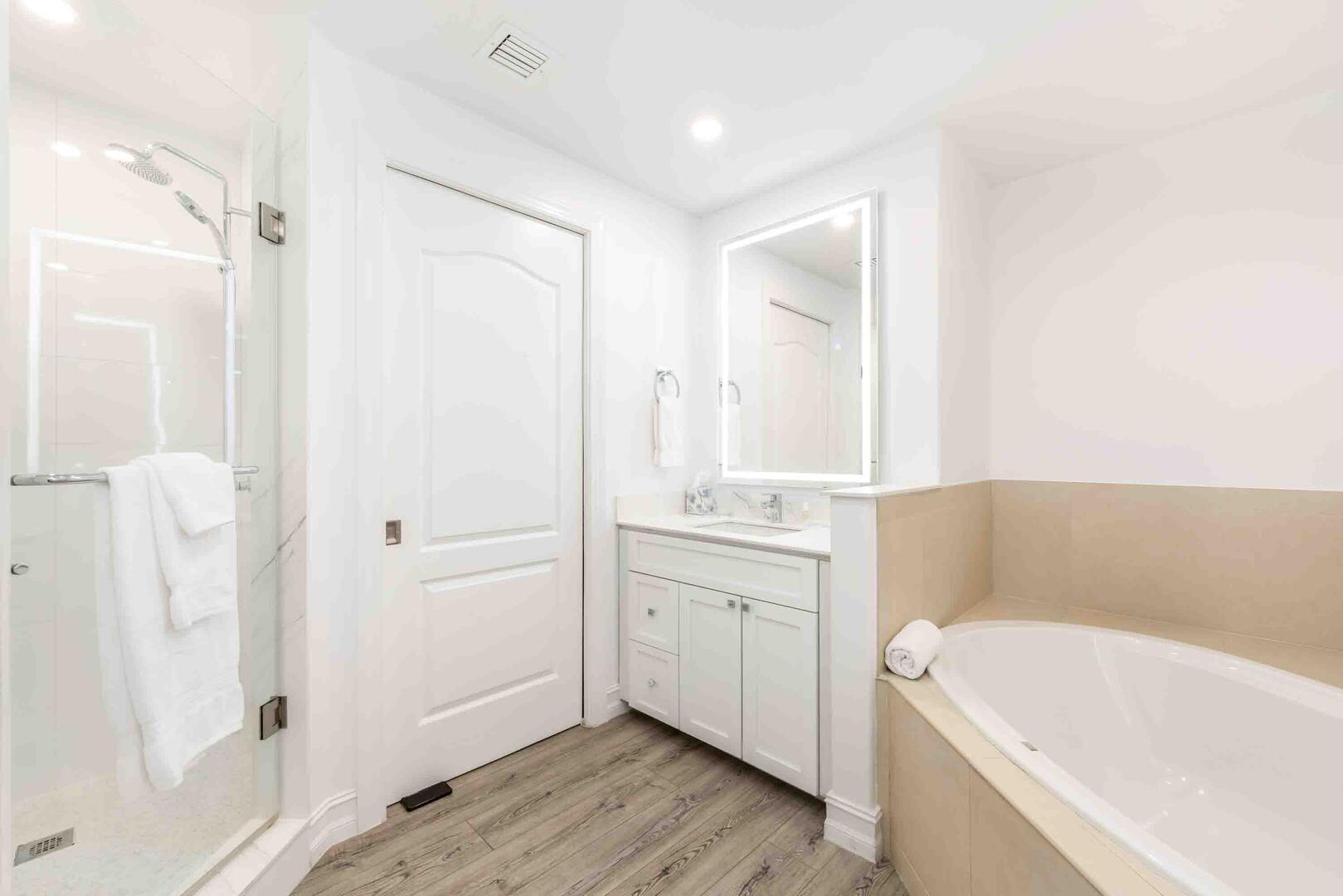 Primary Suite's shower, bathtub, and water closet.