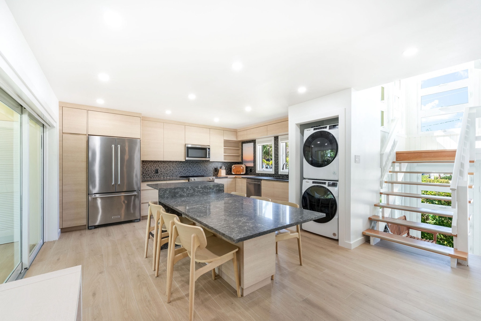 Fully renovated kitchen with stacked laundry closet.