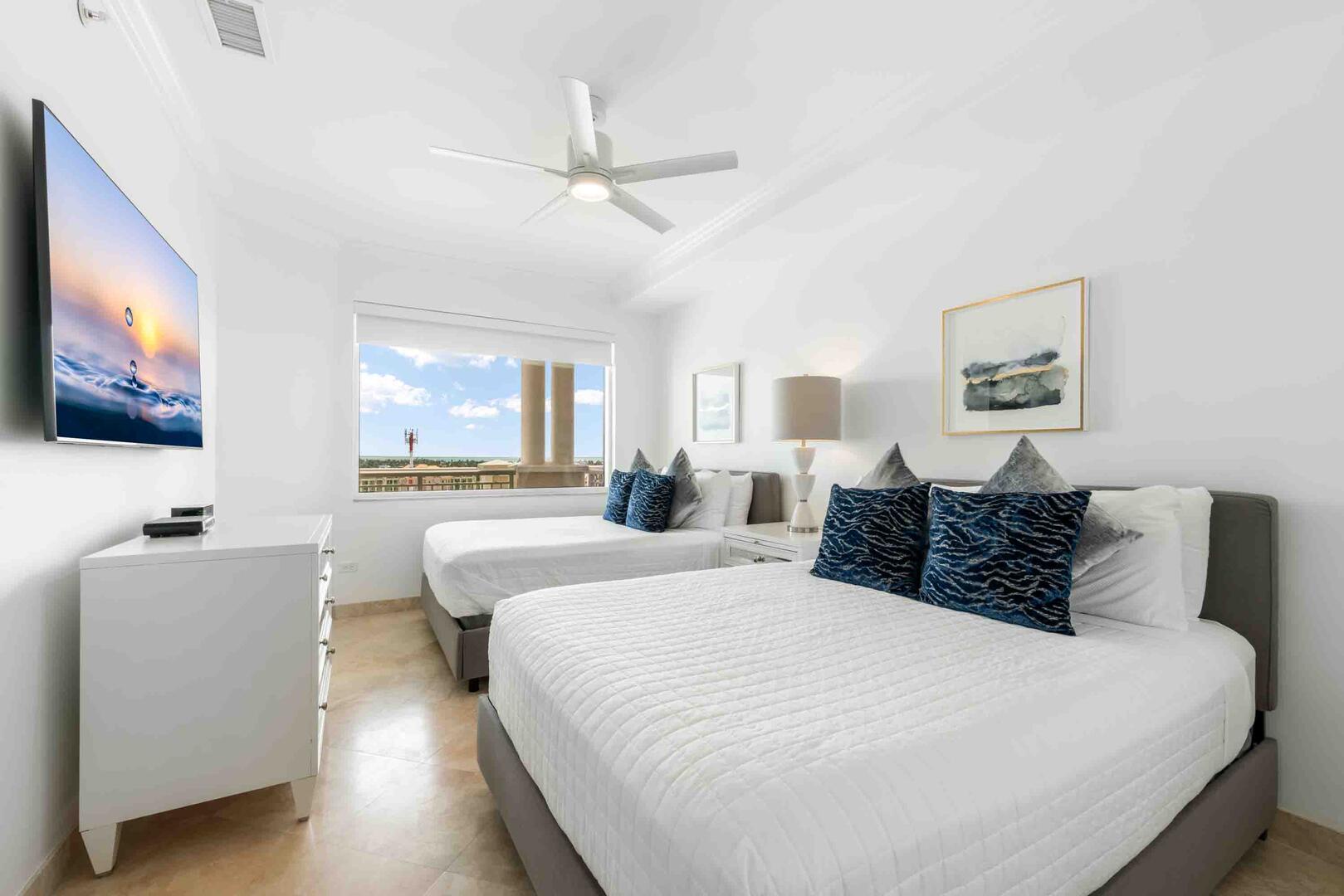 Guest Suite 2 furnished with two queen beds and an HD cable television.