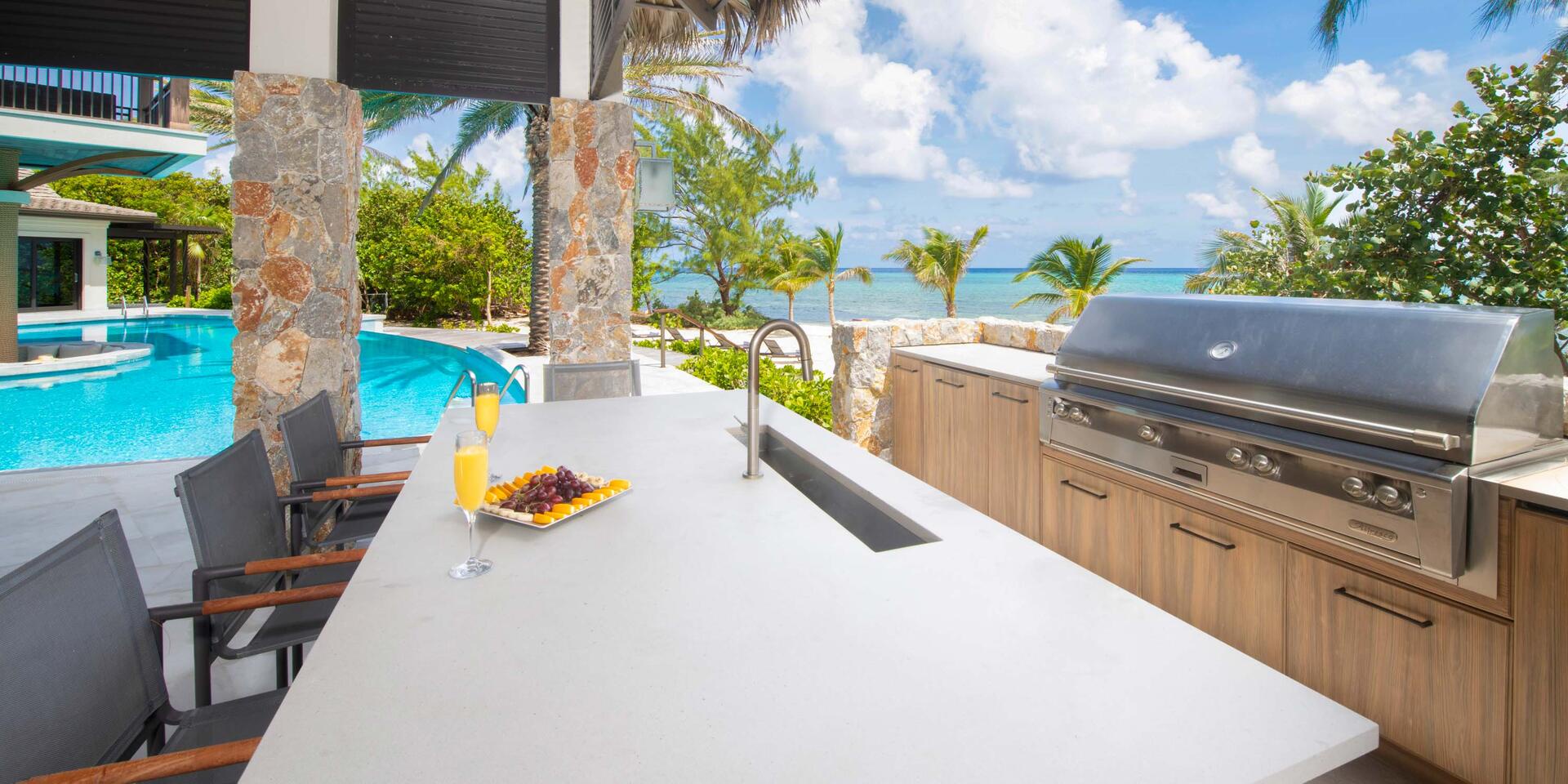 Summer kitchen under the dining pavilion with propane grill and wet bar. Perfect for surf & turf dinners on the beach!