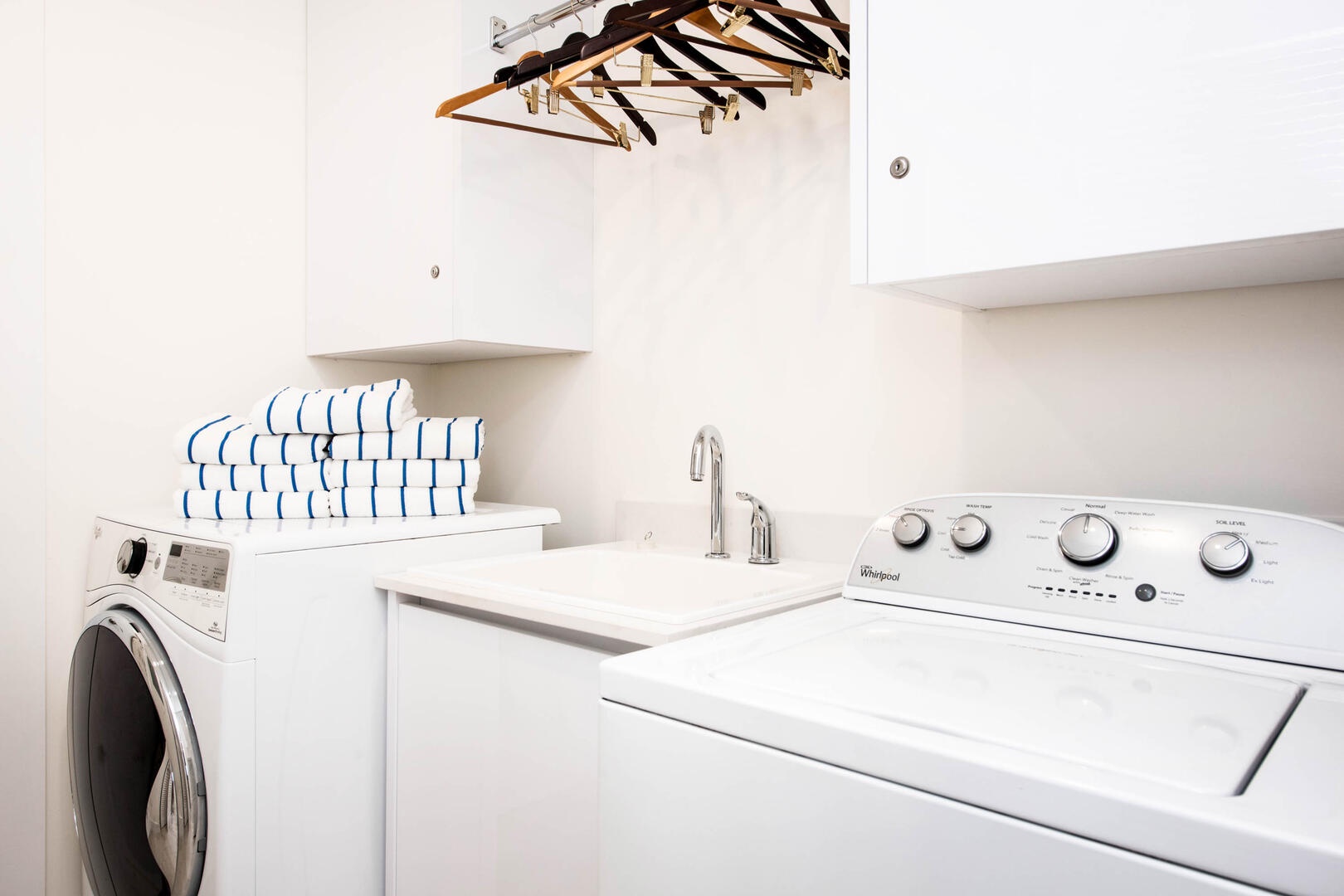 In-unit laundry room with utility sink.