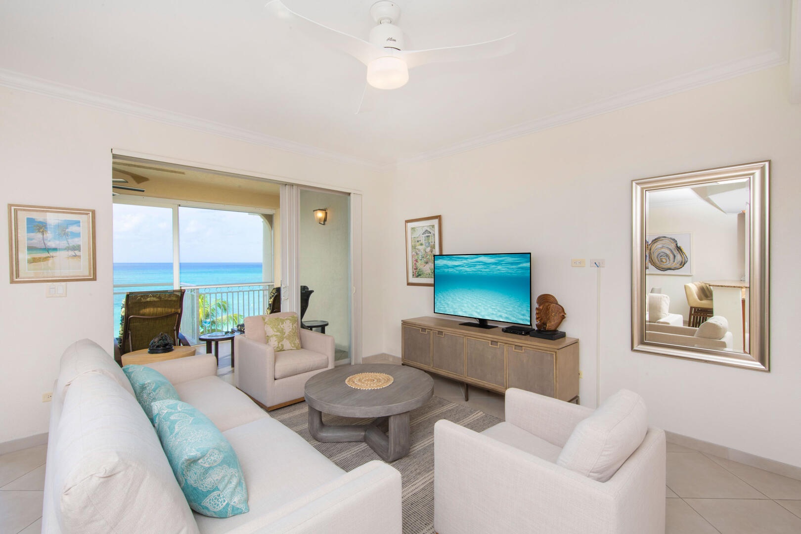 Living area with sofa seating, HD cable TV, and ocean views.