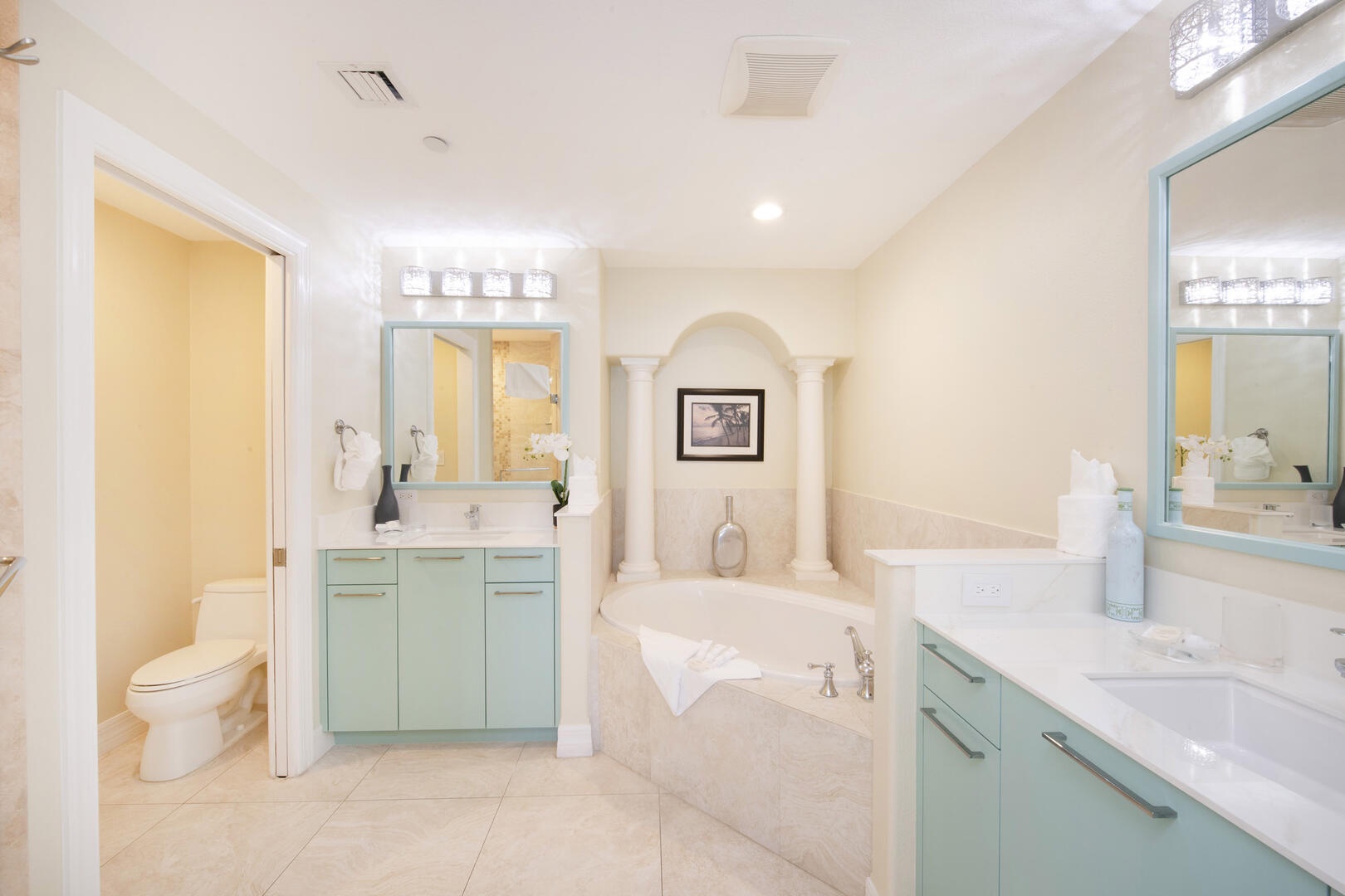 Primary ensuite bath with dual vanity, soaking tub, and separate walk-in shower.