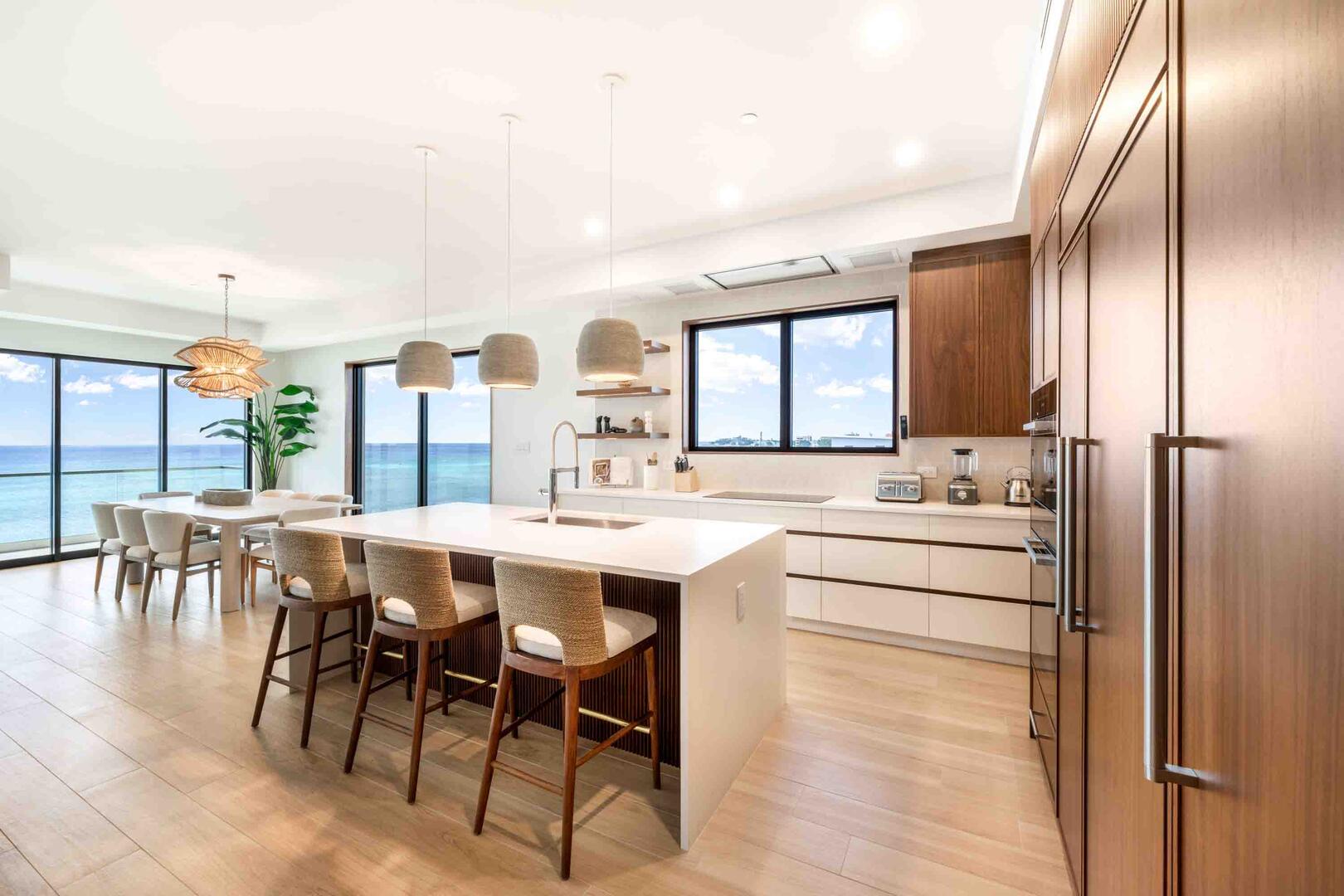 Gourmet kitchen with modern appliances and island seating.