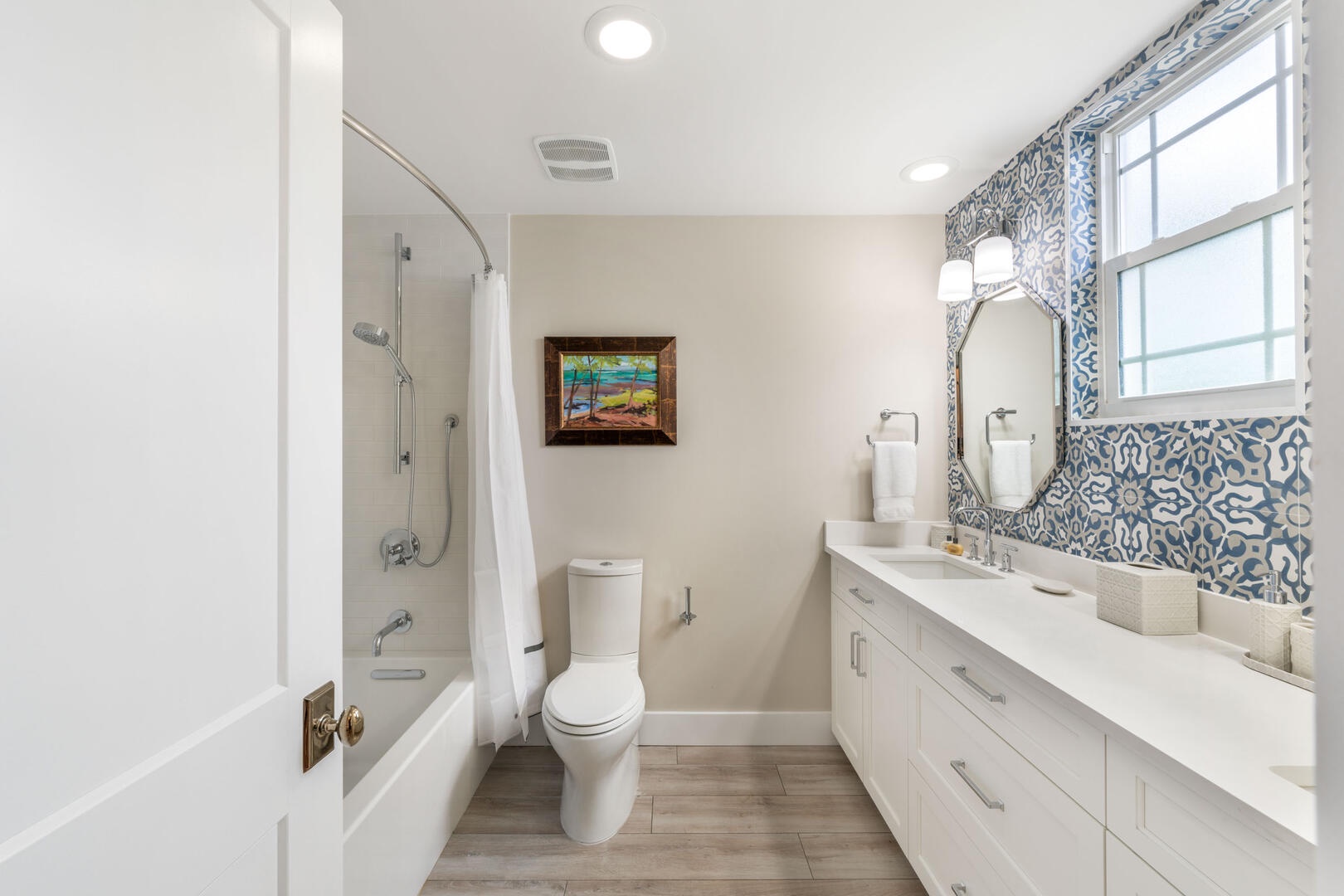 Bedroom #4 shares this hall bathroom equipped with a dual vanity and shower bath.