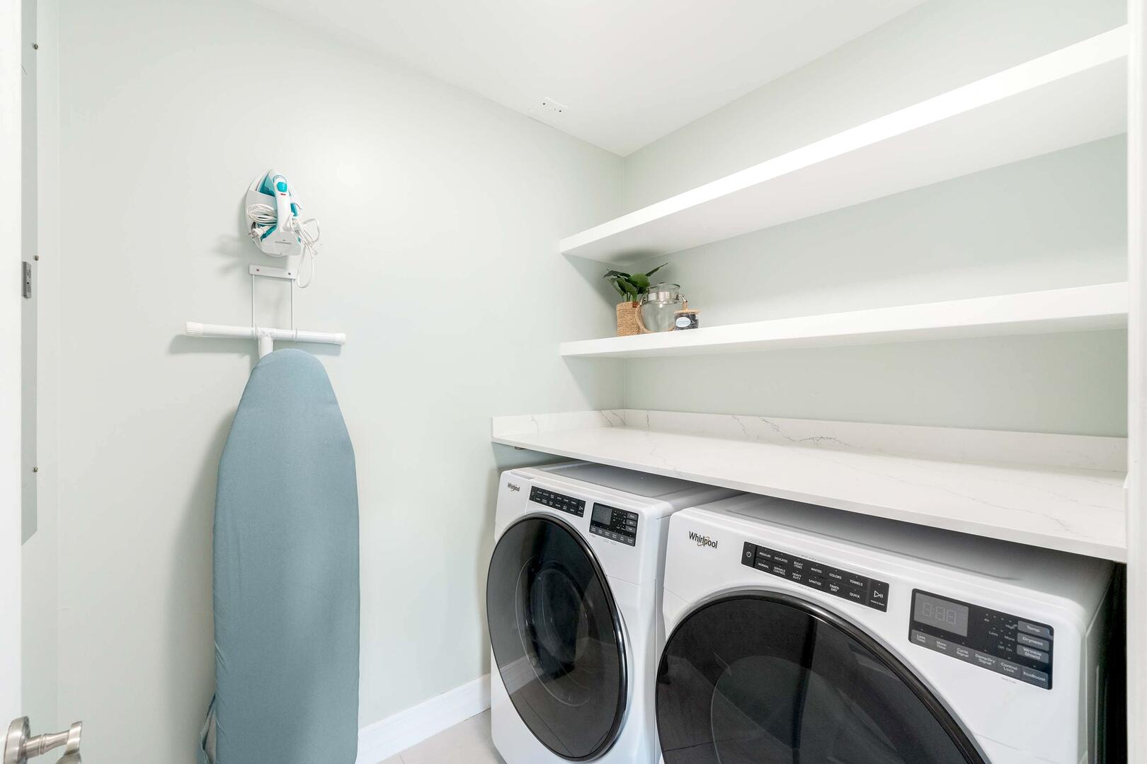In-unit laundry room with washer and dryer.