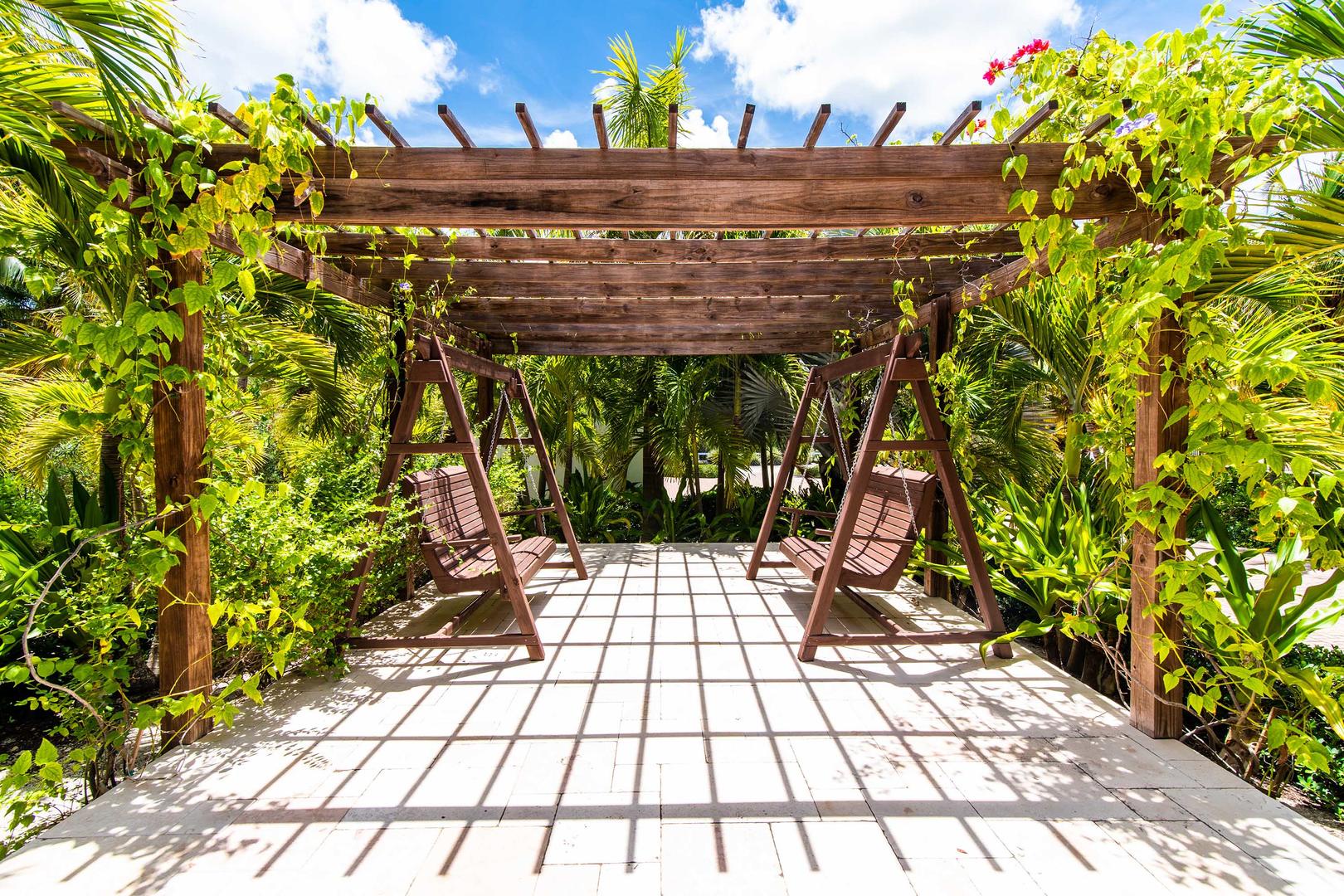 Entry garden with trellis and bench swings.