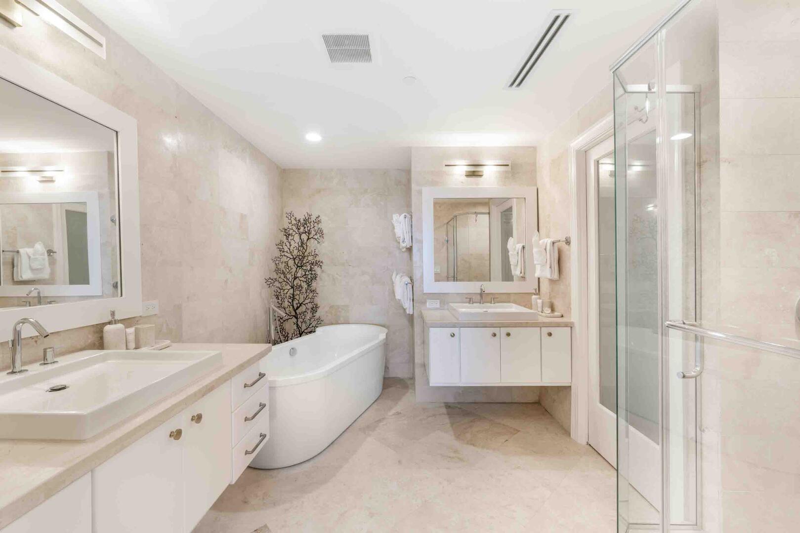 Primary Ensuite with dual vanity, soaking bathtub, and separate shower.