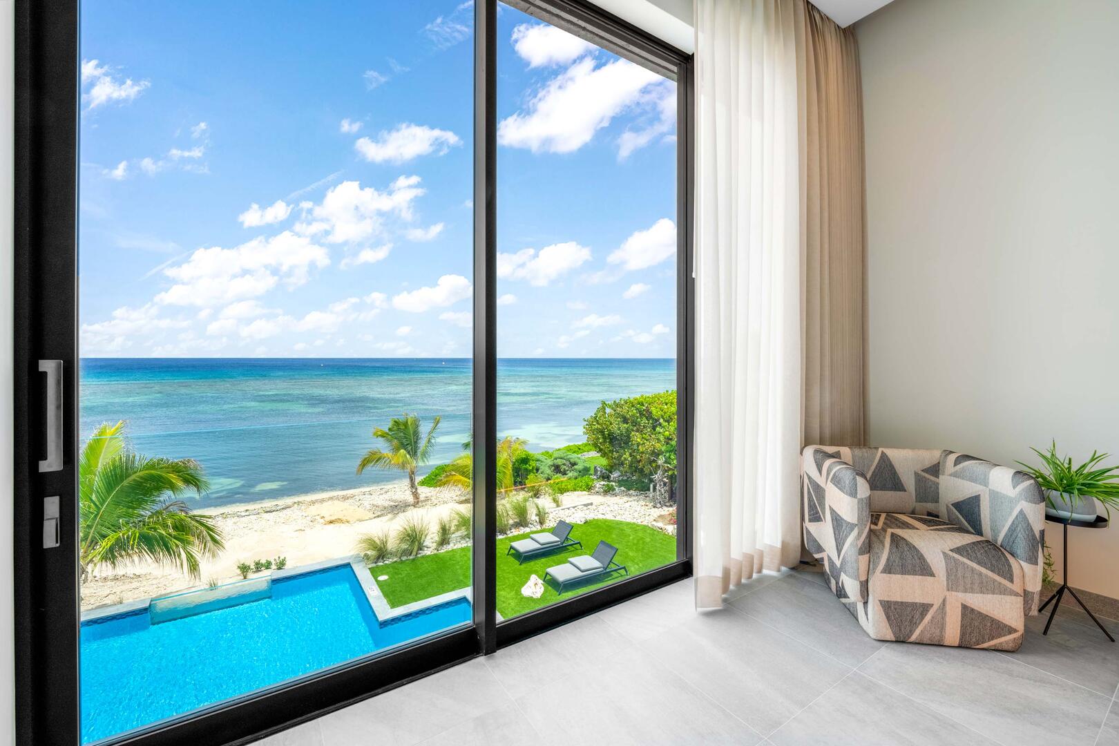 Oceanfront king suite 3 - king platform bed, desk, oceanfront floor-to-ceiling glass doors, 65" TV w/swivel mount, beverage fridge, coffee center, upholstered chair, sofa