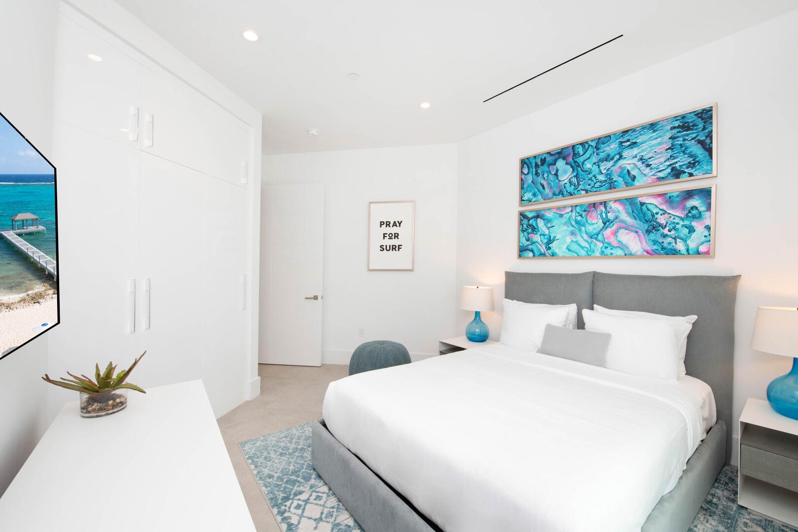 Guest Bedroom 1: king bed, SmartTV, closet, shares adjacent bathroom equipped with a shower bath.