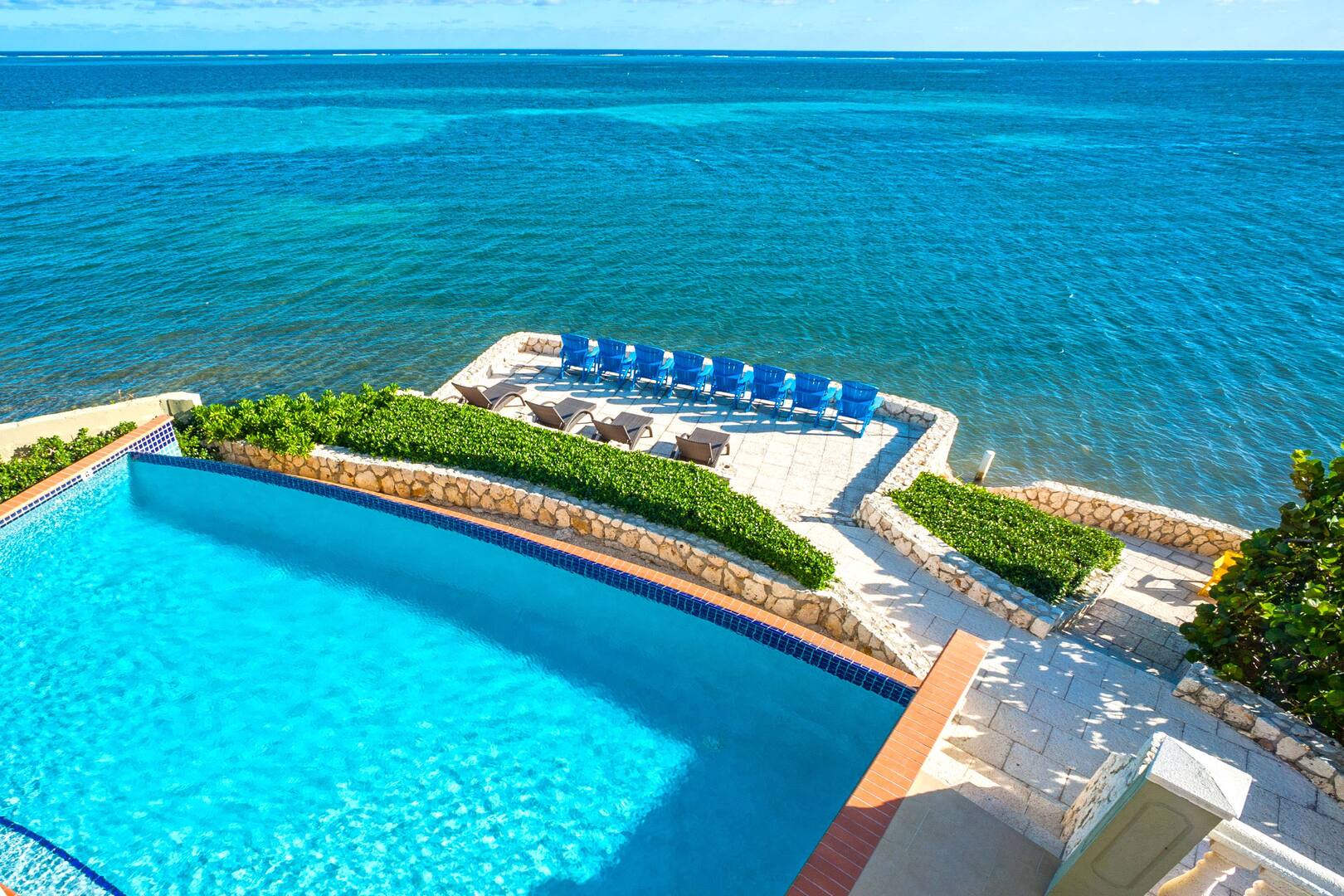 View of the pool and ocean terrace at Cayman Castle.