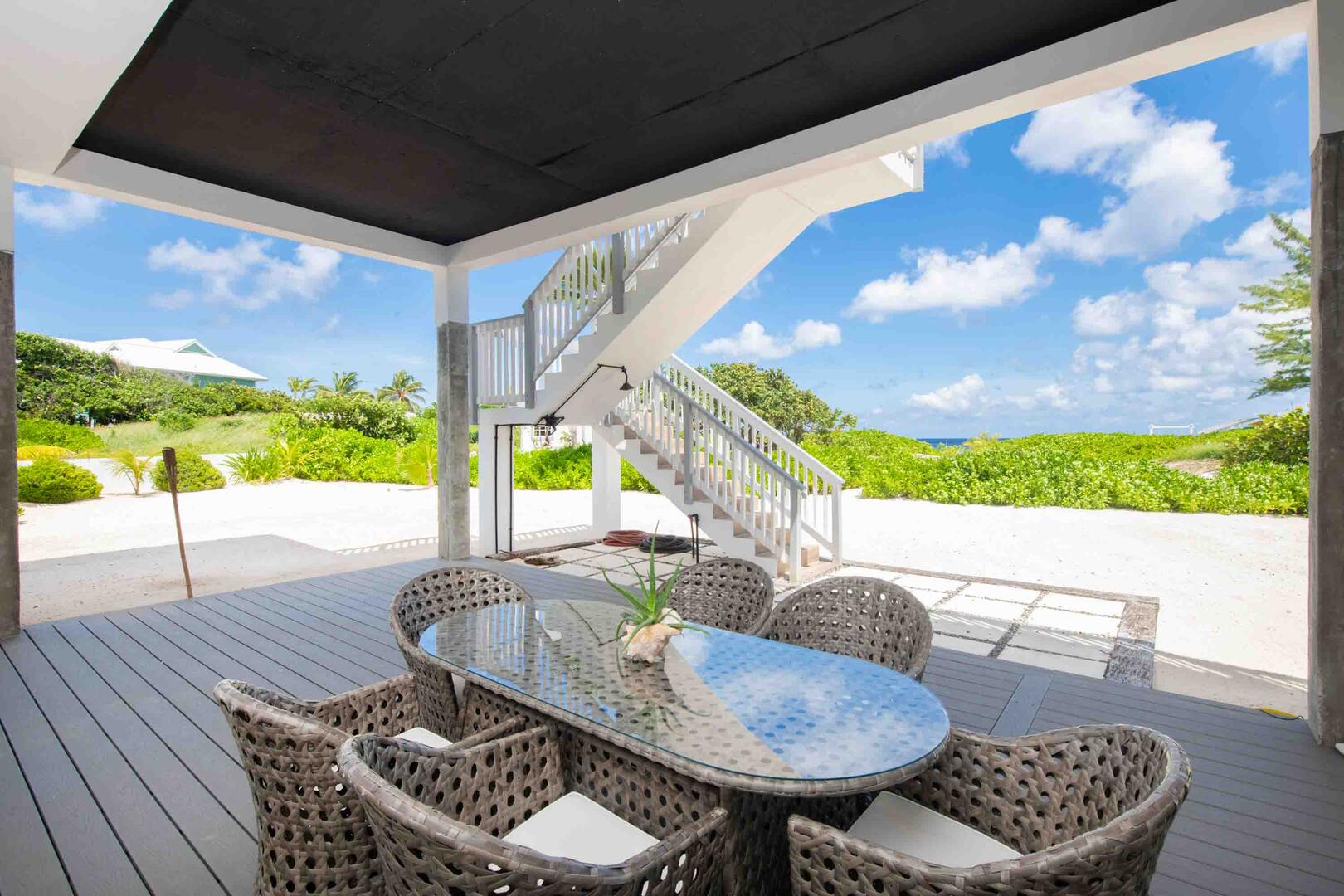 A second alfresco dining table sits on the lower level patio.