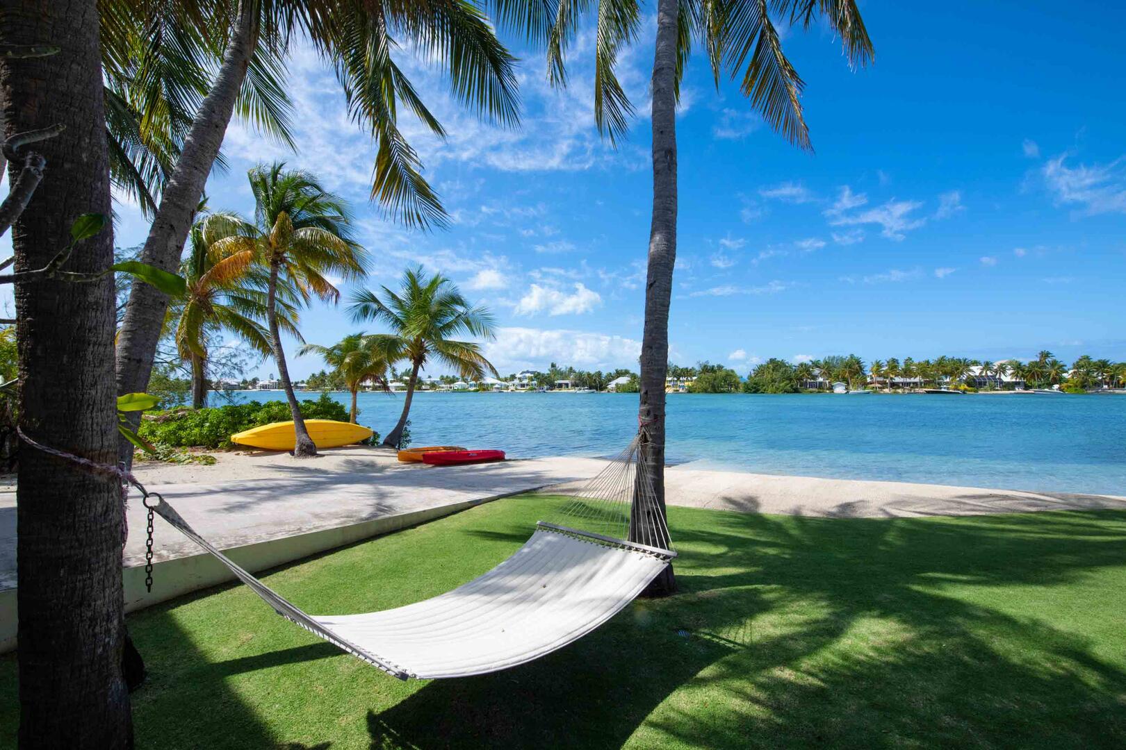 Private manicured beachfront with seaside hammock.