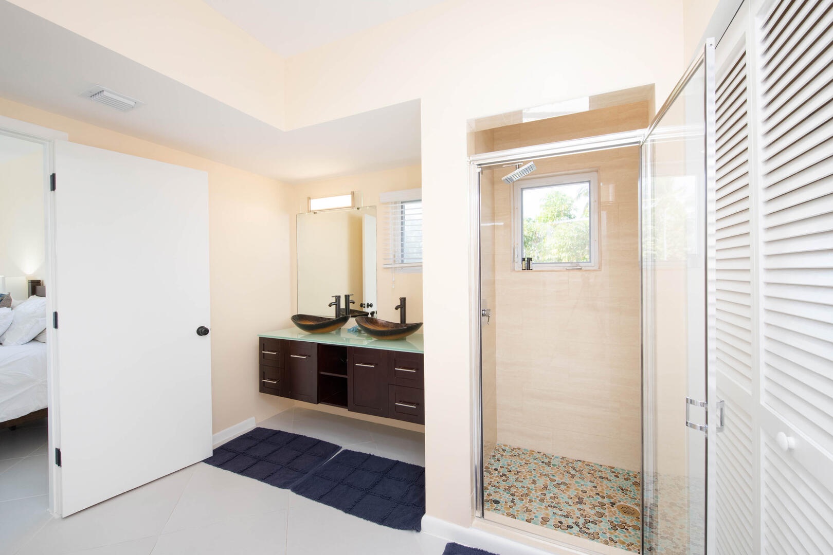 Guest ensuite with dual vanity and shower.