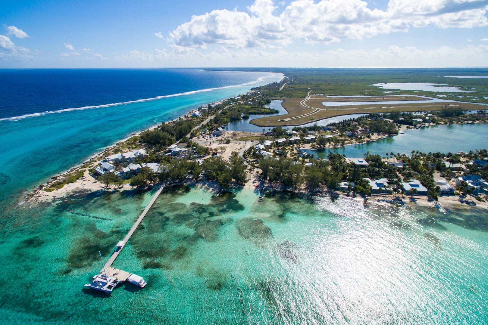 Aerial view of the Rum Point Club, a public beach across the street with food + drink plus watersports.