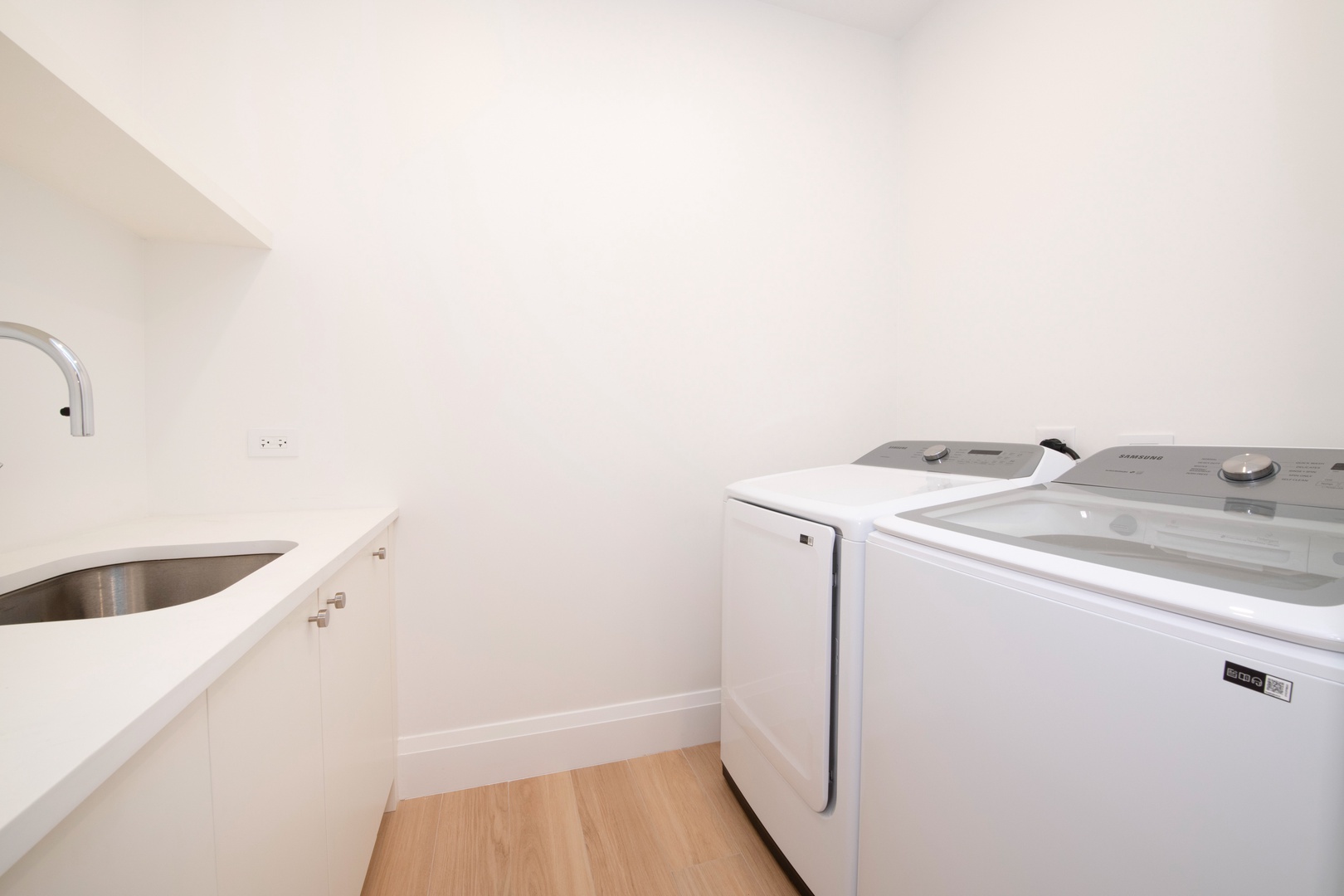In unit laundry room with washer and dryer.