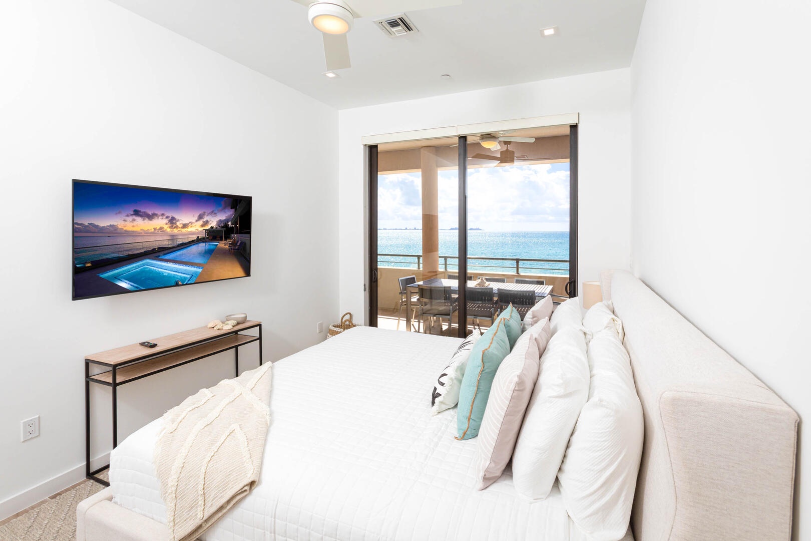 Primary Suite with television and walk-out access to the balcony.