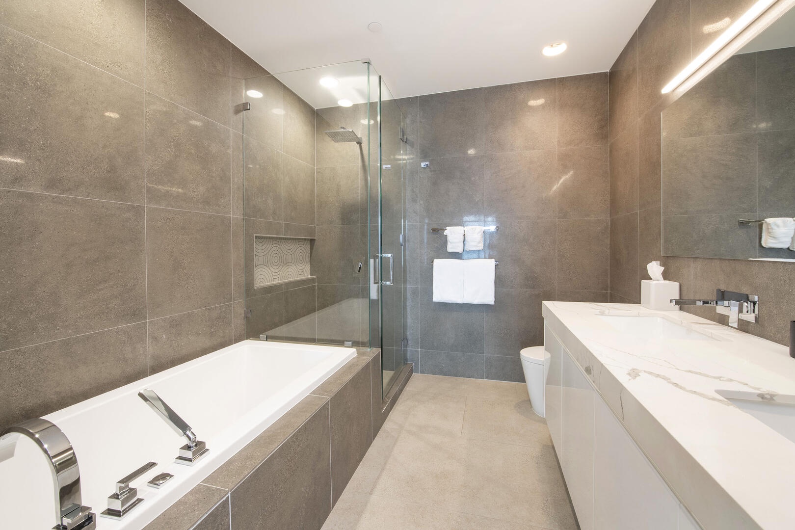 Primary Ensuite with dual vanity, soaking tub, and walk-in shower.