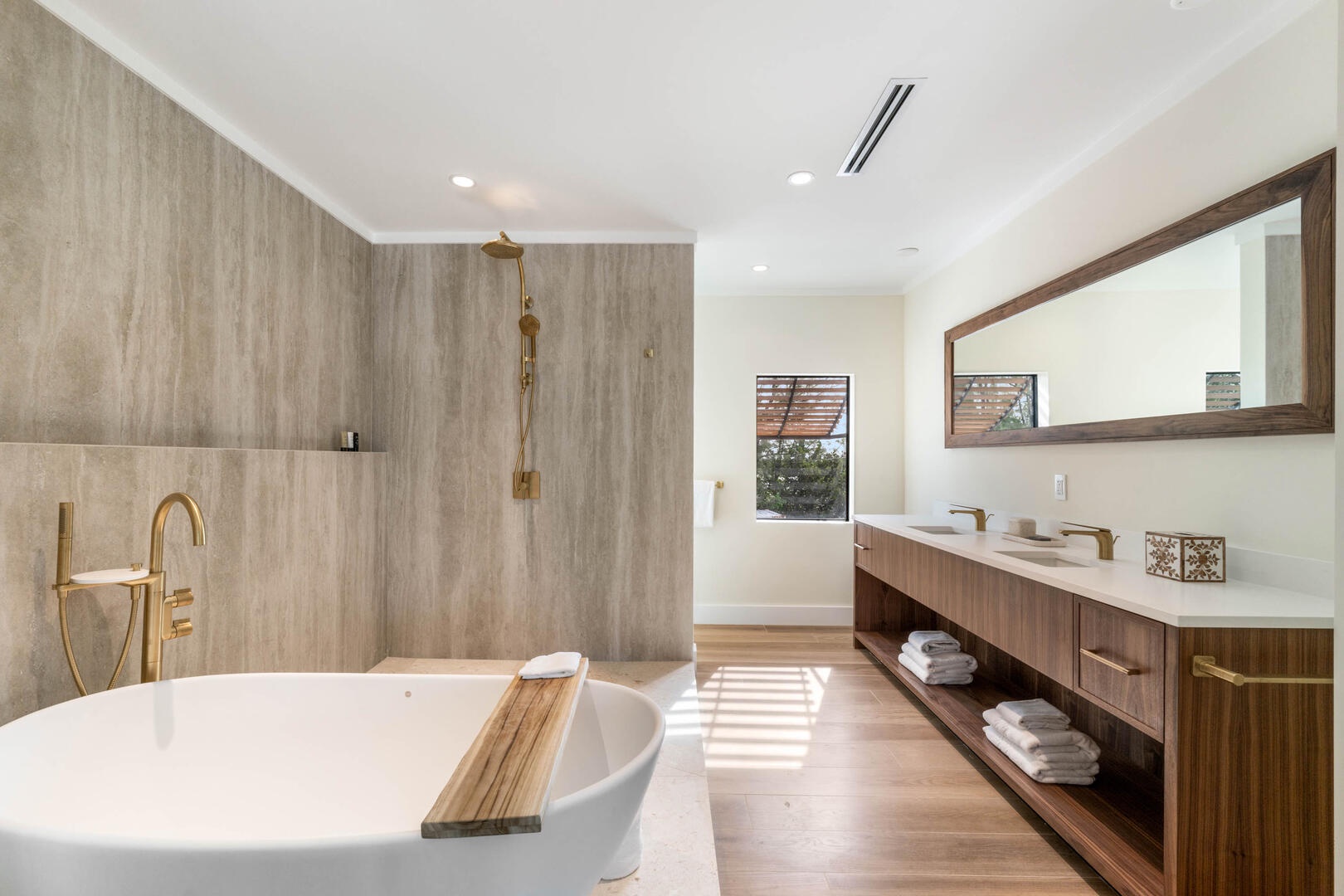 Bedroom 2 ensuite with dual vanity, soaking bathtub, and separate shower.
