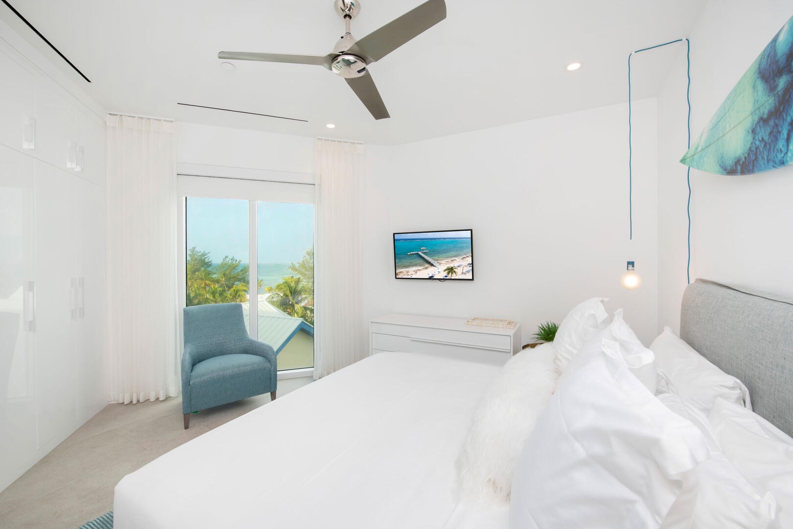 Guest Bedroom 2: queen bed, SmartTV, closet, shares adjacent bathroom equipped with a shower bath.