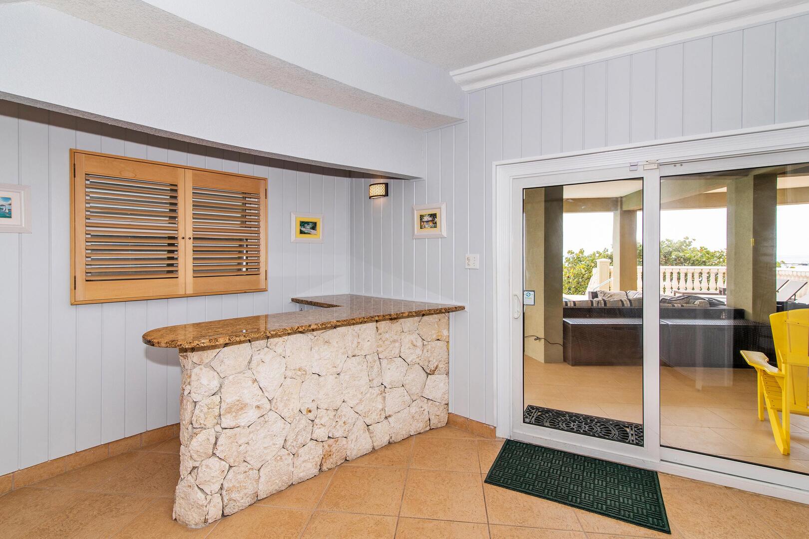 Bar on the lower level just off the pool deck includes a beverage fridge.