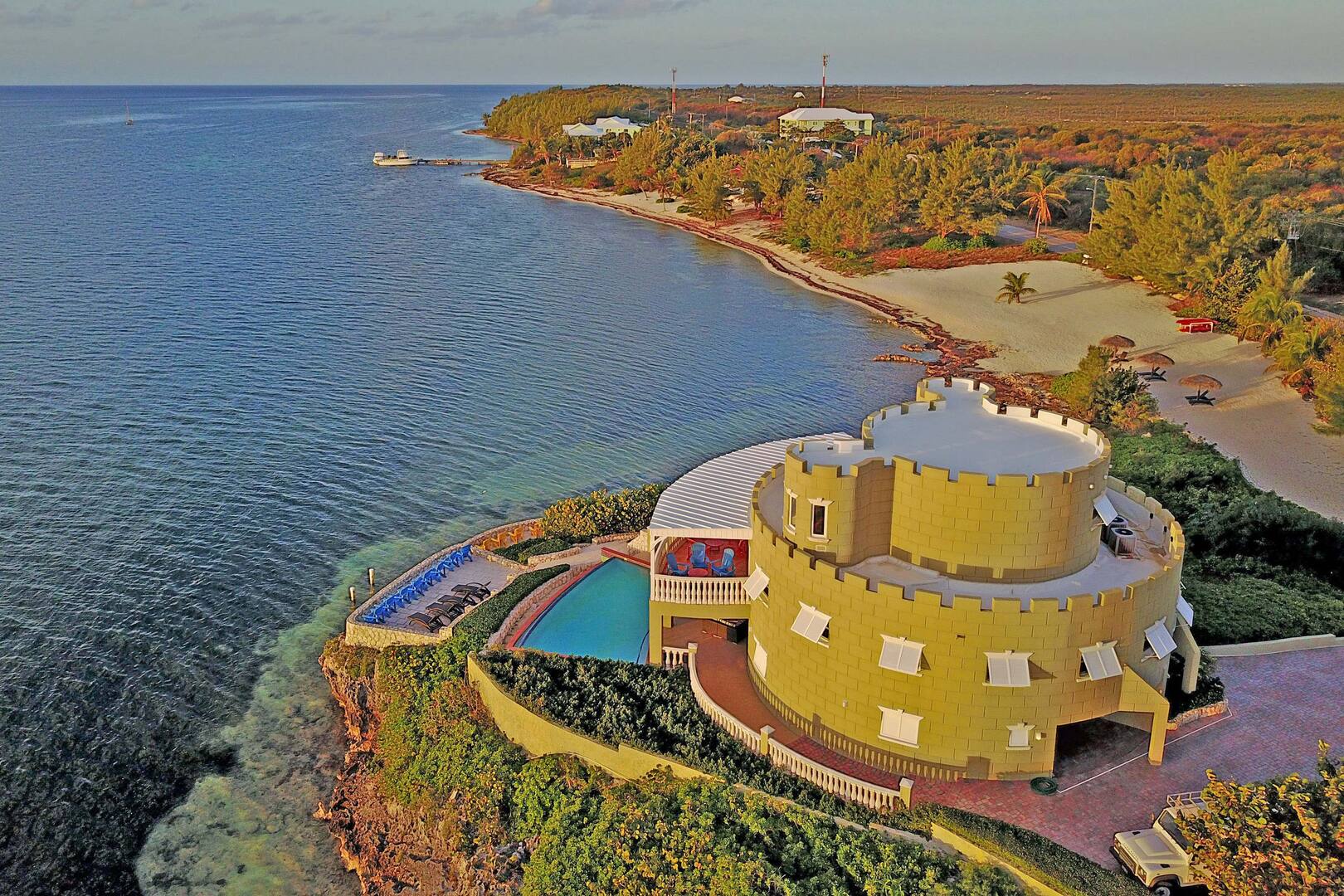 Aerial view at sunrise. The beach on the right is villa's private beachfront at the end of the driveway.