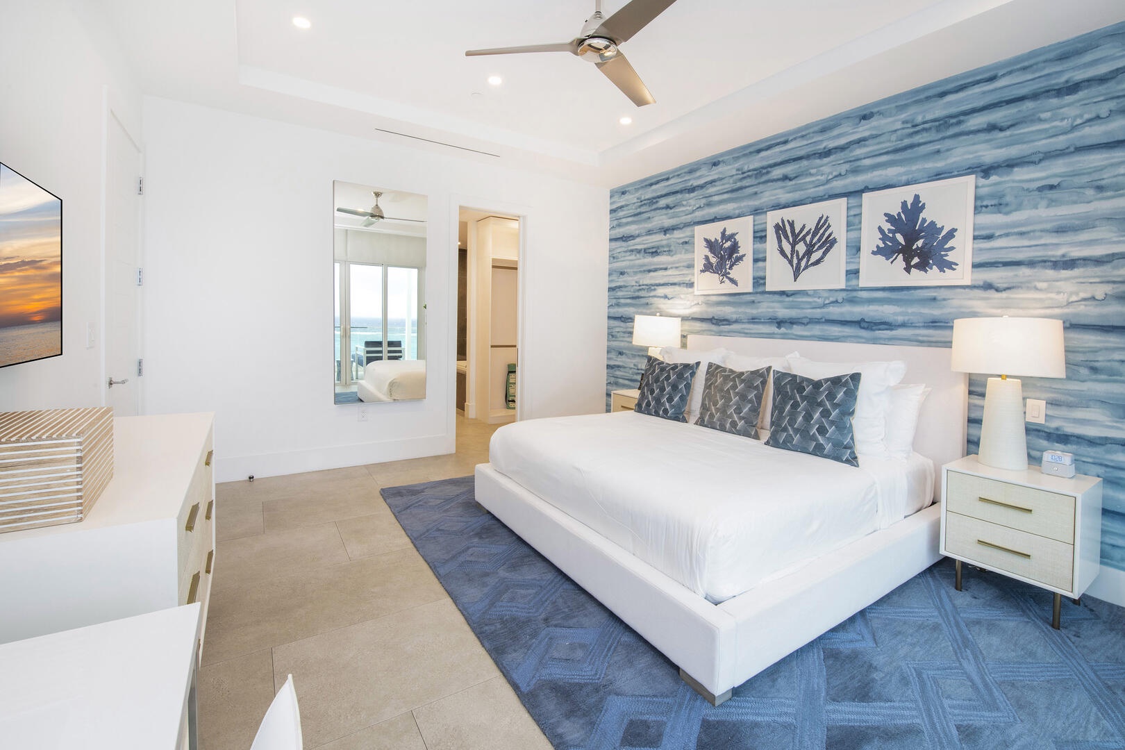 Primary suite equipped with a SmartTV, and a walk-thru closet leading to the ensuite.