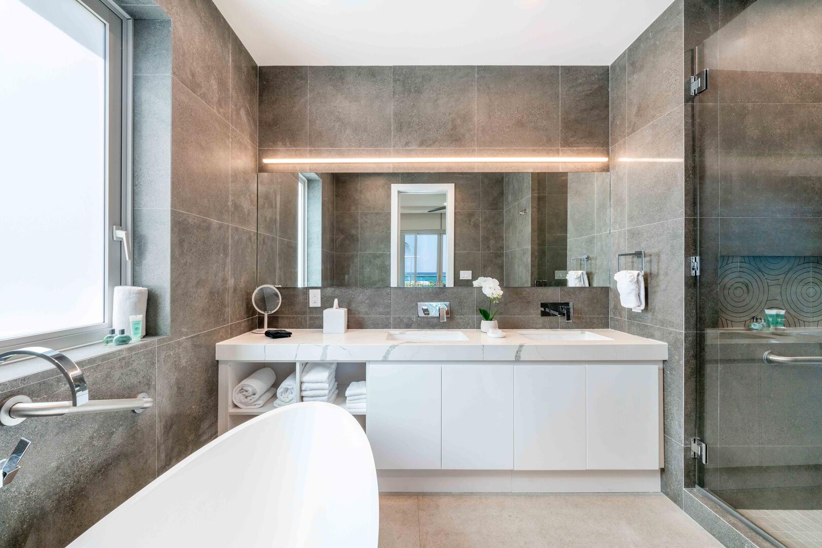 Primary Ensuite with dual vanity, soaking bathtub, and separate shower.