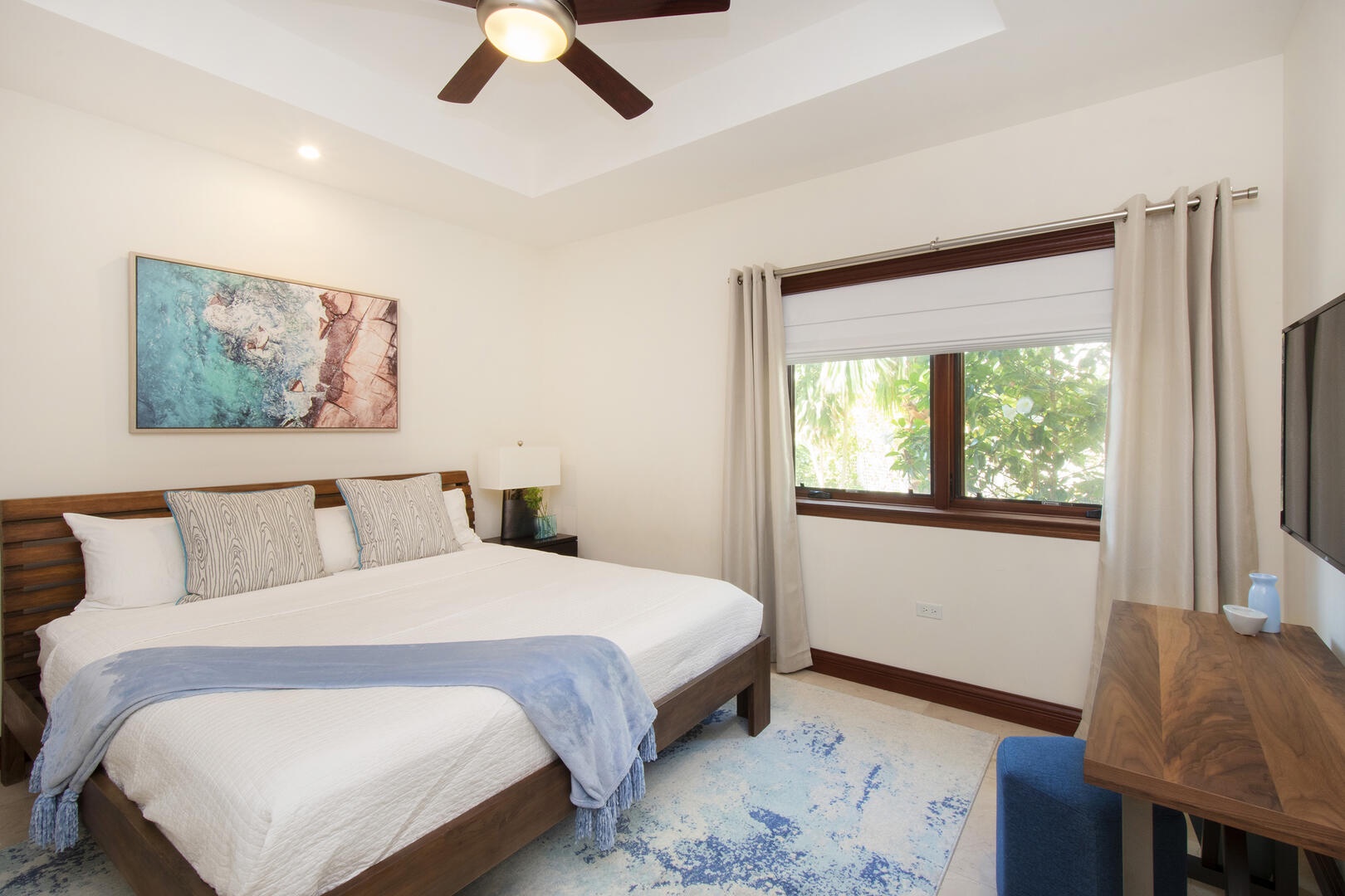 Guest Suite #1 sits on the lower level of the home and comes furnished with a king bed and television.