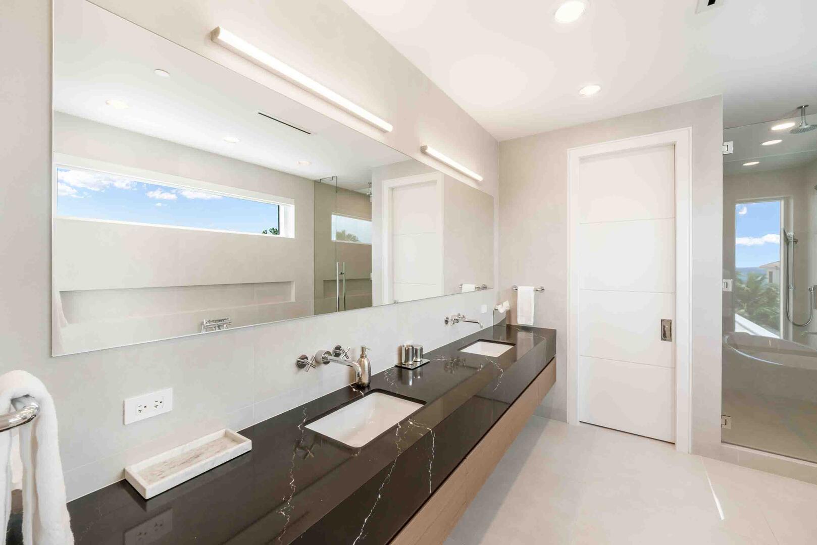Bedroom 1 ensuite is equipped with dual vanities, a soaking bathtub, and a separate shower.
